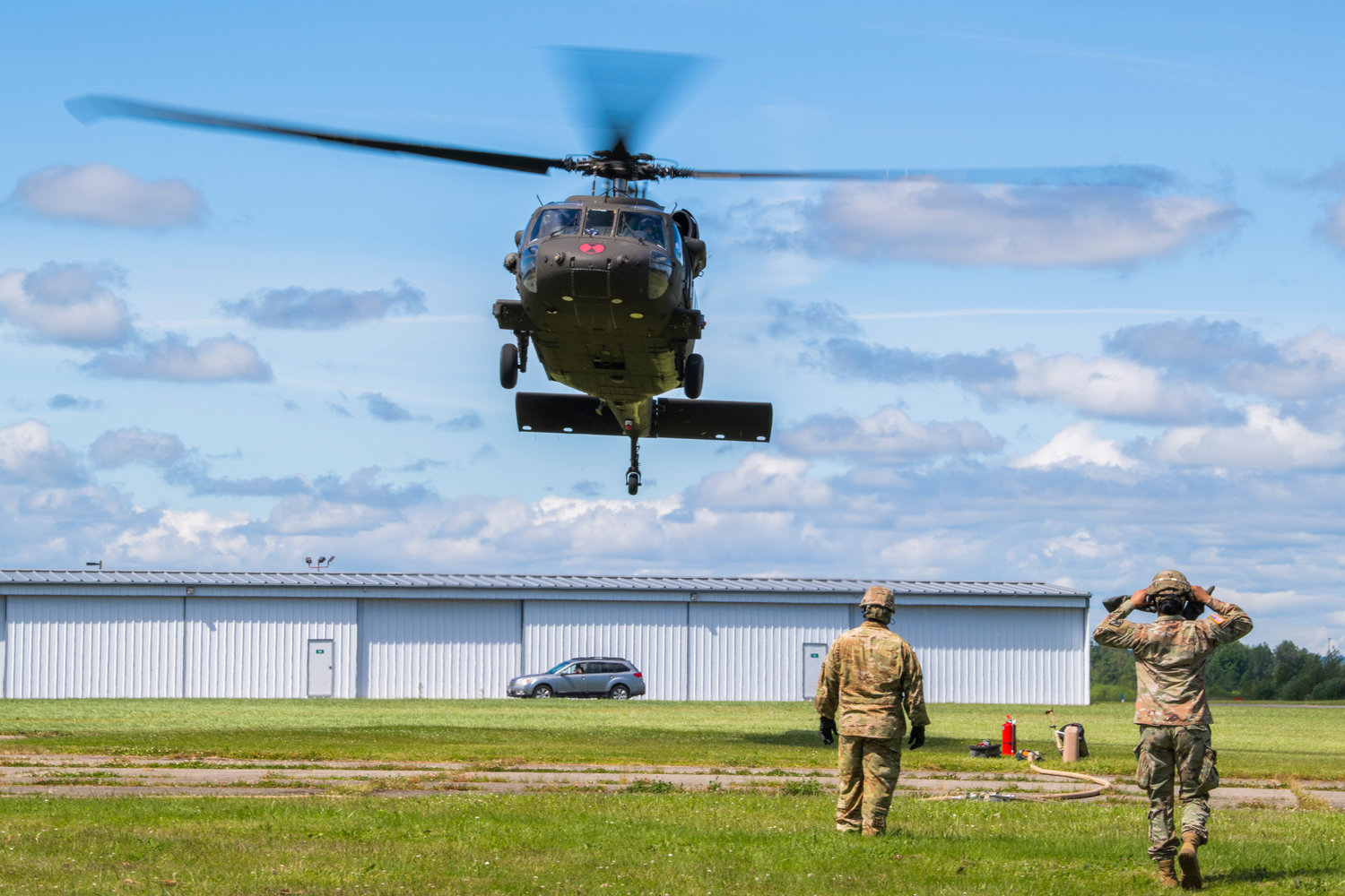 A Black Hawk helicopter from Joint Base Lewis-McChord hovers above the Chehalis-Centralia Airport on Wednesday afternoon. The airport hosted training exercises focused on refueling helicopters.