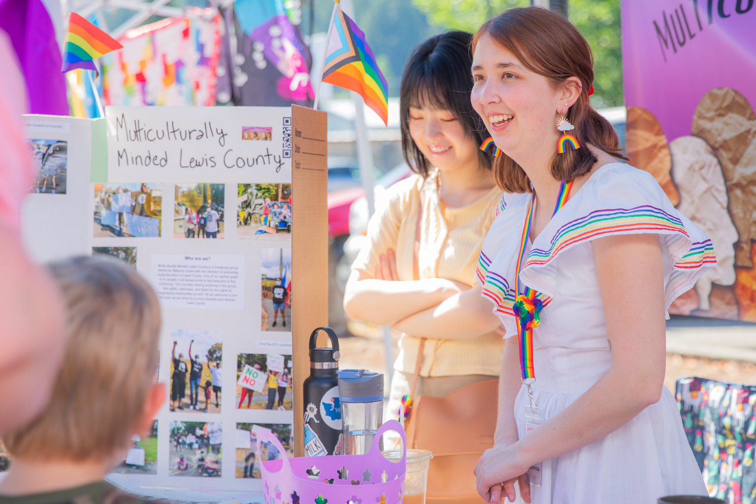 Lujan Rodriguez smiles and greets visitors at a Multiculturally Minded Lewis County booth during a pride event in downtown Centralia on Saturday.