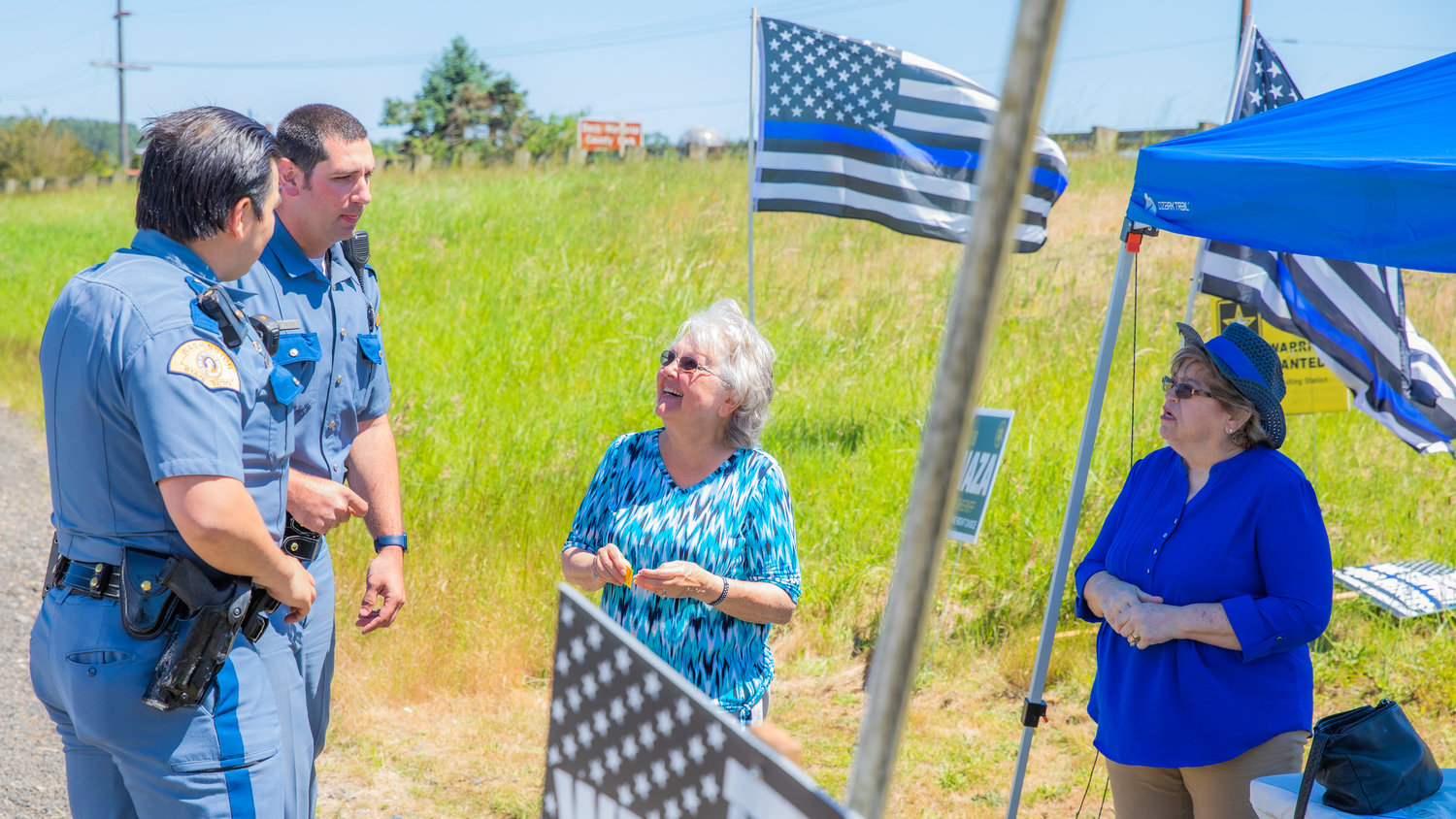 Members of the Washington State Patrol mingle with attendees at a “Back the Blue” event in Adna on Saturday. The event was hosted by Adna Grocery.