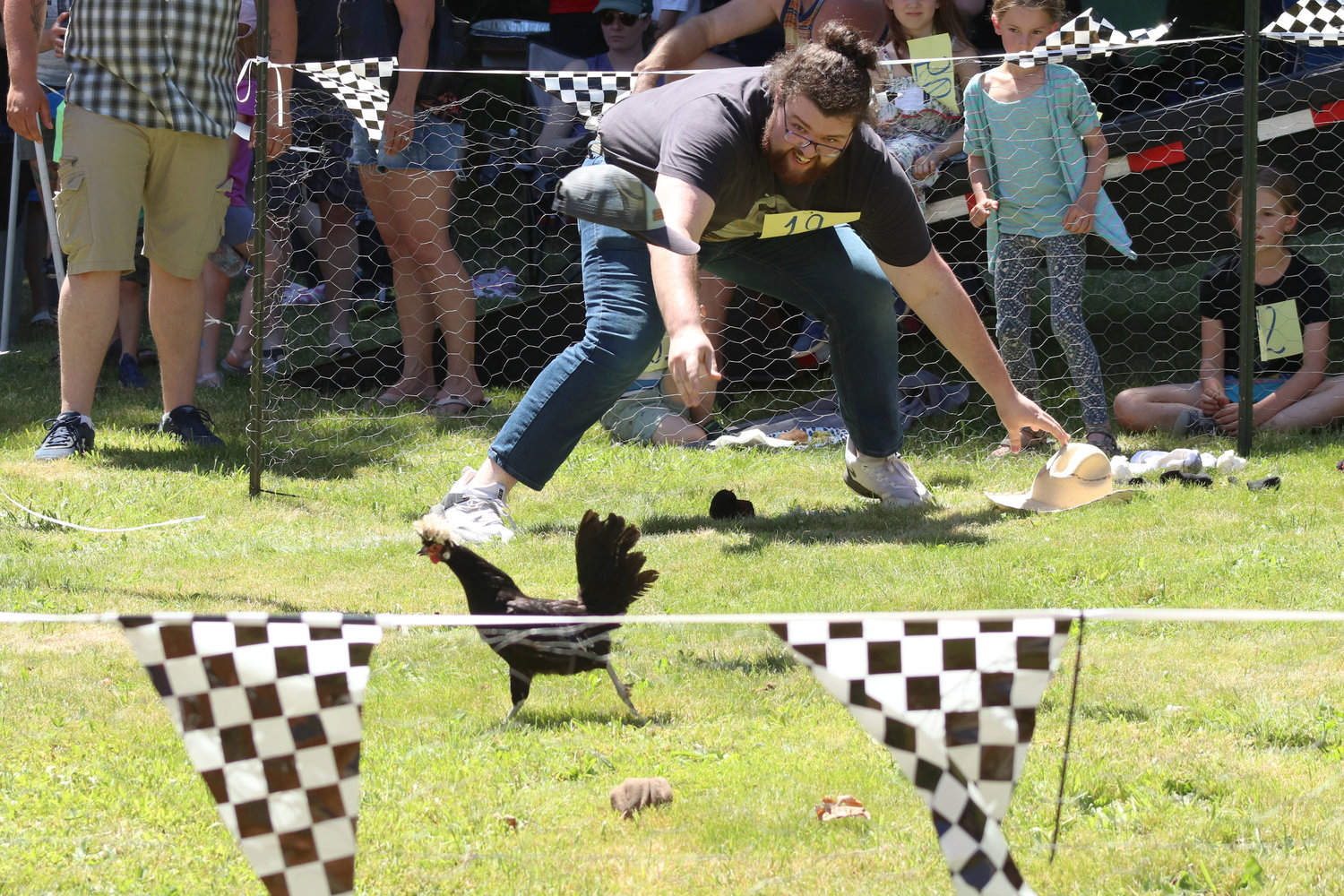 FILE PHOTO — Parker Ashton throws a cap at a chicken during Independence Valley Community Hall’s 42nd Annual Chicken Races in Rochester in 2022.