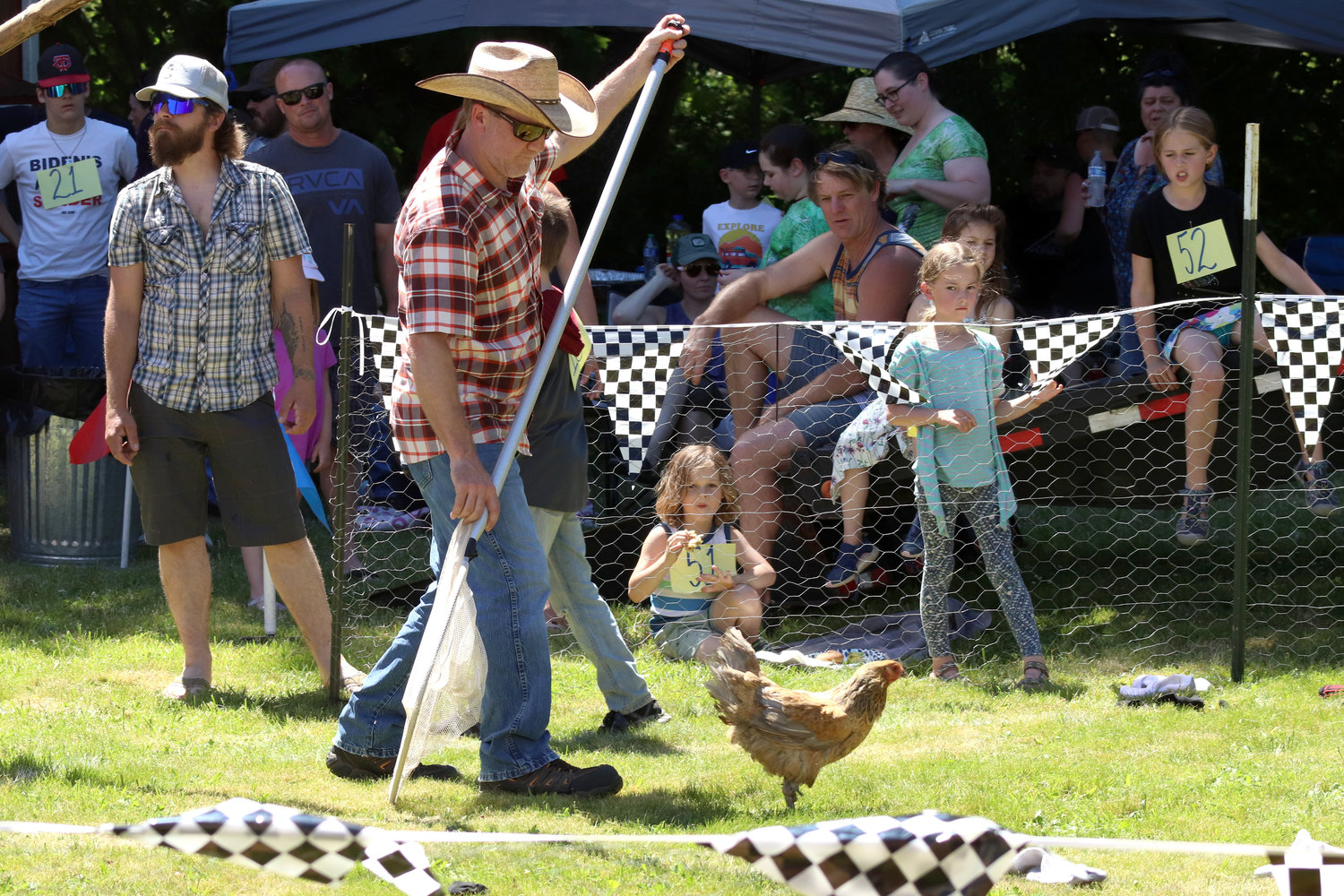 A volunteer prepares to scoop up a chicken with a net during Independence Valley Community Hall’s 42nd Annual Chicken Races in Rochester on Sunday.