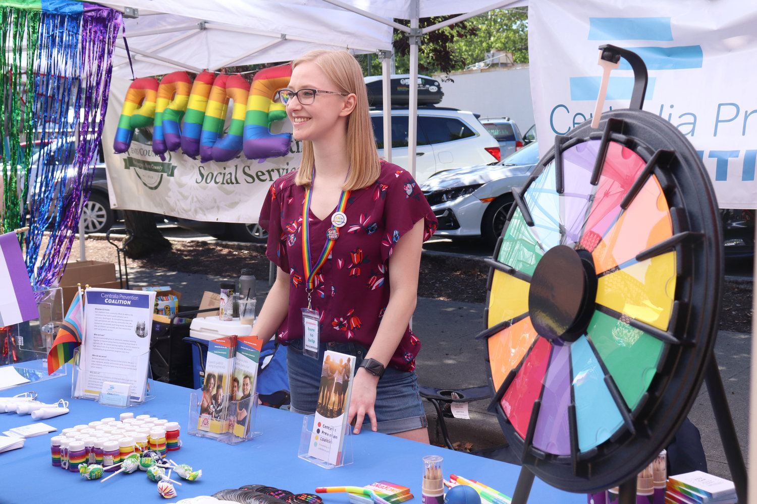 Sara Bumgardner of the Centralia Prevention Coalition attends a rainbow prize wheel at Lewis County Pride in Centralia on Saturday.