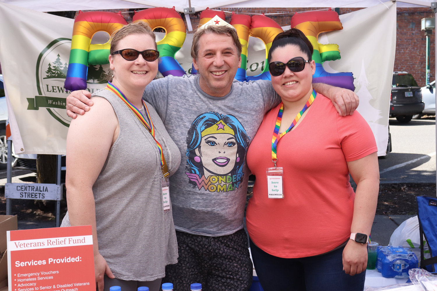From left, Lindsey Shenkle, Bryan Hall and Justia Madrigal of Lewis County Public Health & Social Services pose for a photo at Lewis County Pride in Centralia on Saturday.