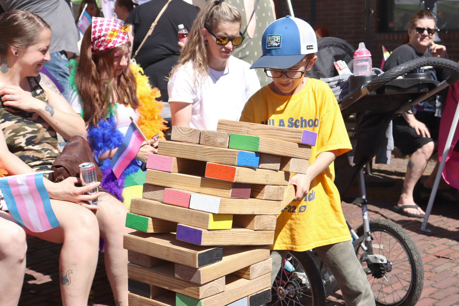 Stanford Castonguay, 7, extracts a block from a crumbling Jenga tower during Lewis County Pride in Centralia on Saturday.