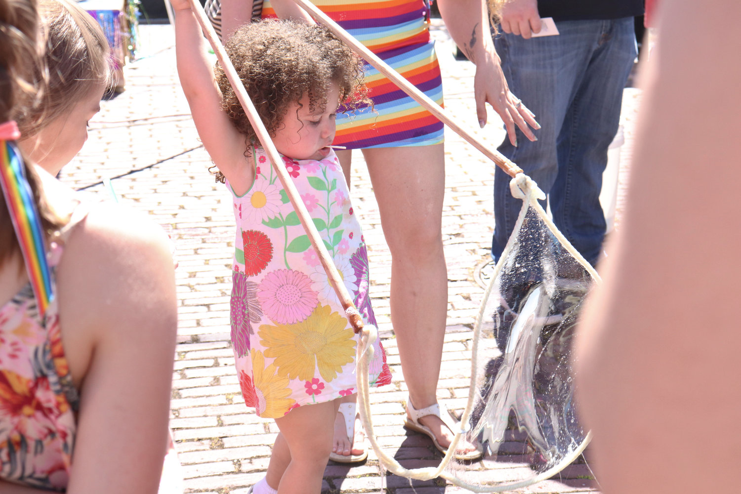 Layla, 1, creates a giant bubble during Lewis County Pride in Centralia on Saturday.