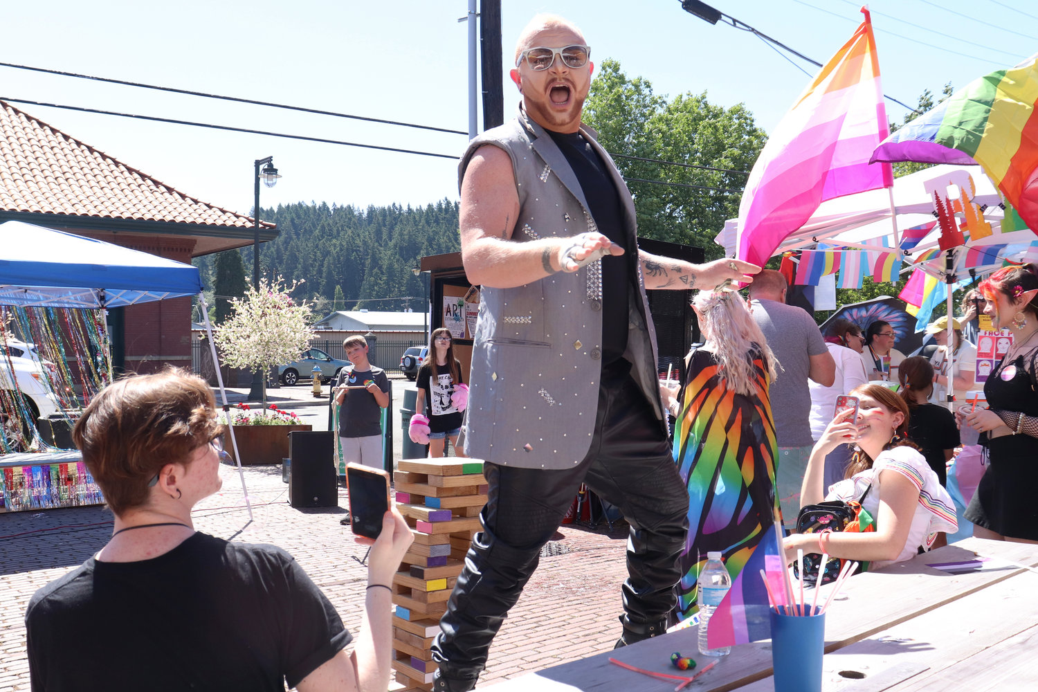 Freddy Prinze Charming jumps up on a table during a performance at Lewis County Pride in Centralia on Saturday.