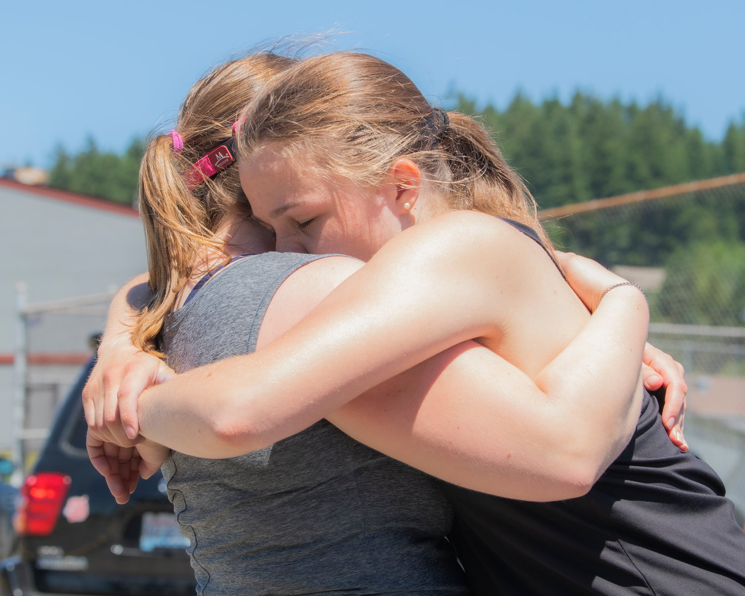 Emma Lund hugs Isabel Vander Stoep during the Jack State Tennis Tournament at W.F. West High School on Saturday.