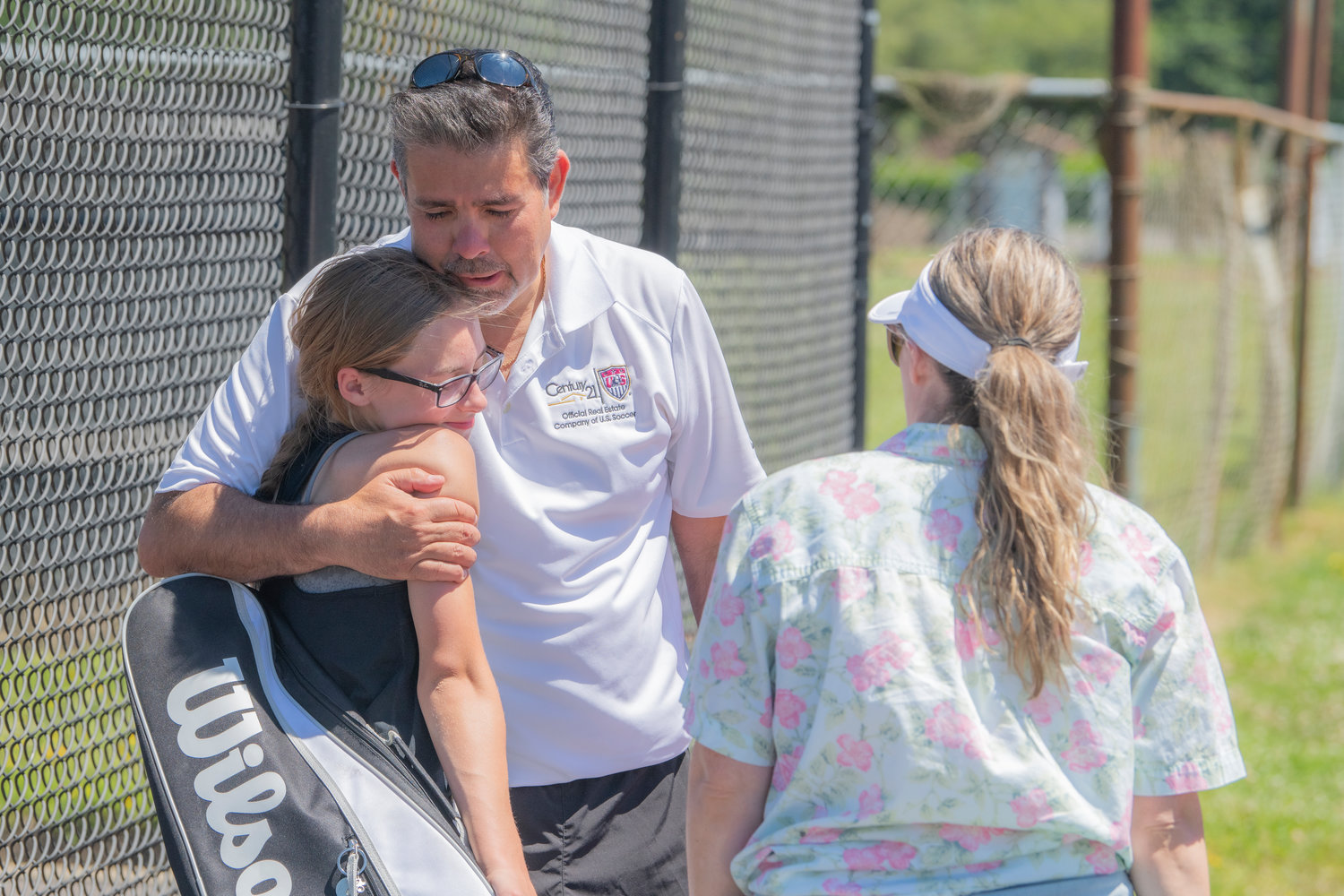 Katelyn Wood embraces Walter Cuestas during the Jack State Tennis Tournament at W.F. West High School on Saturday.