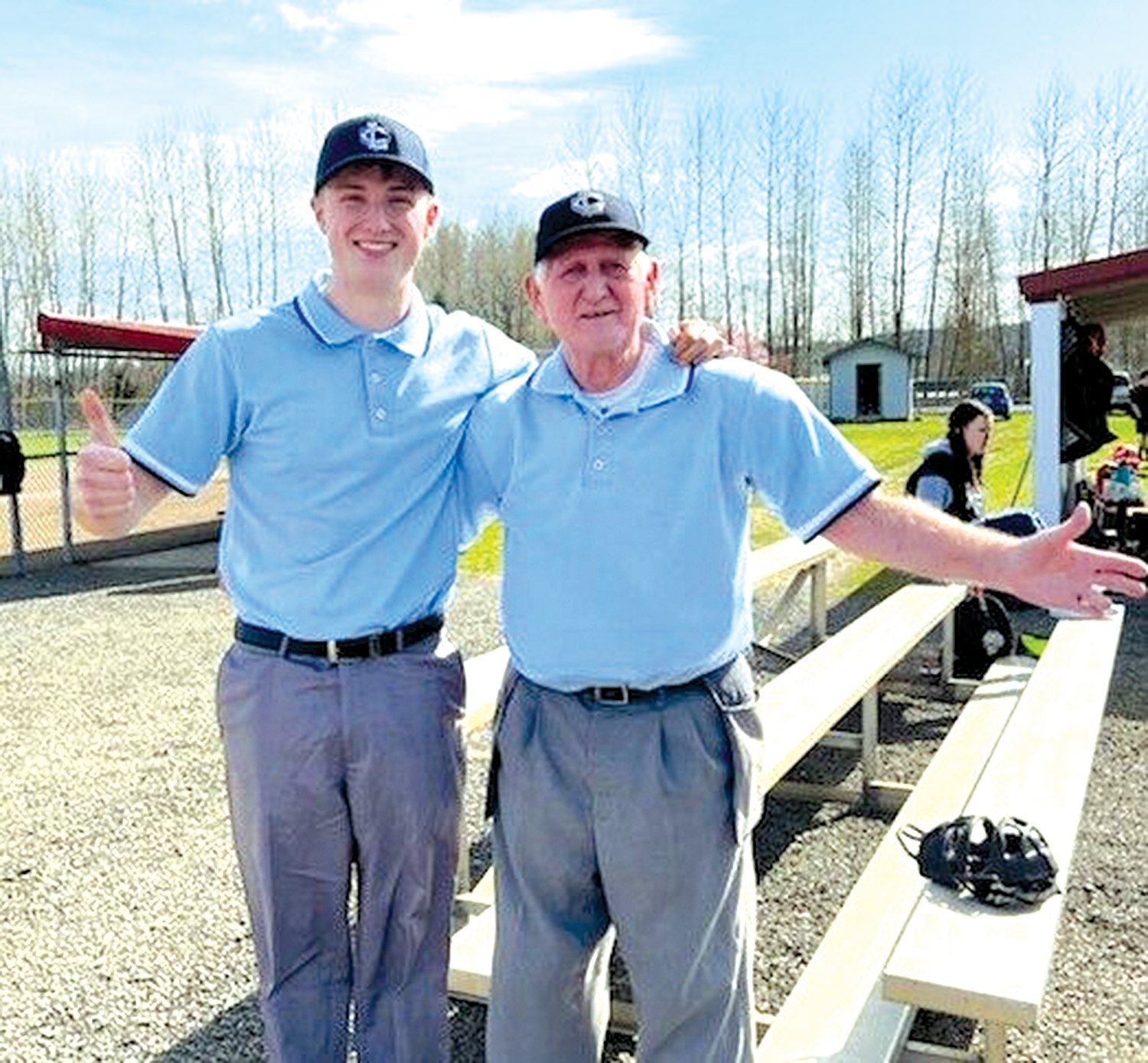 Logan Setera, left, and his great-grandfather Gordon Dunn pose together after umpiring a game together.