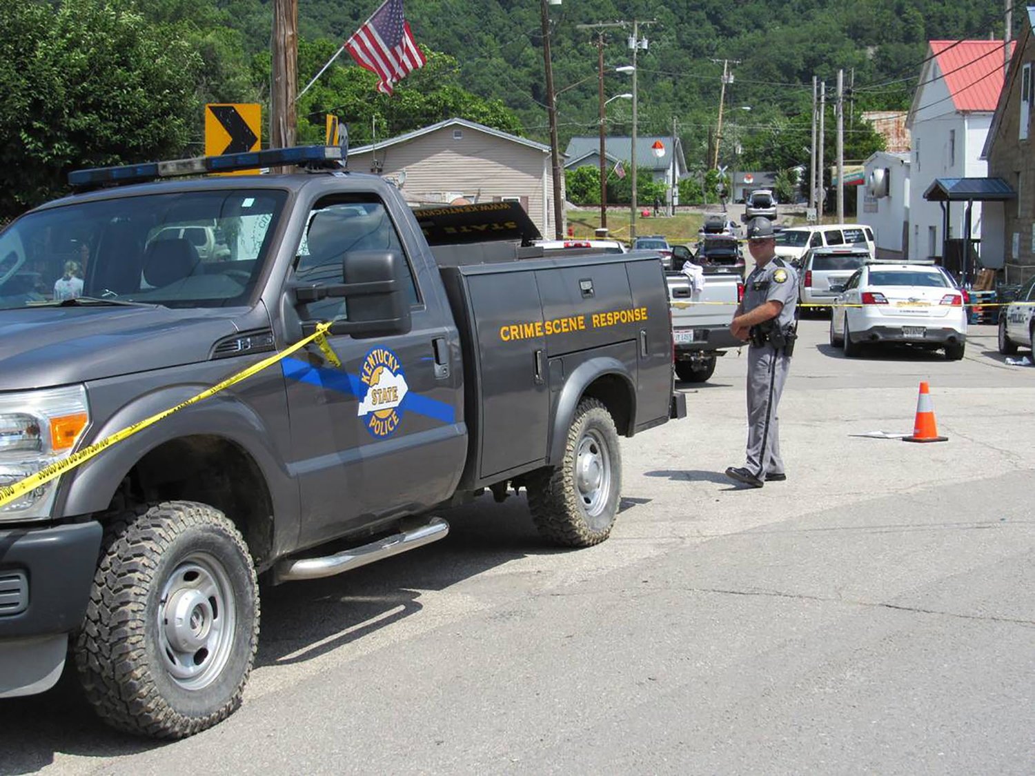 Kentucky State Police officers block off a street in Allen, a small town in Floyd County, Kentucky, on July 1, 2022, as the investigation continues into a shooting in which three police officers were killed. (Bill Estep/Lexington Herald-Leader/TNS)