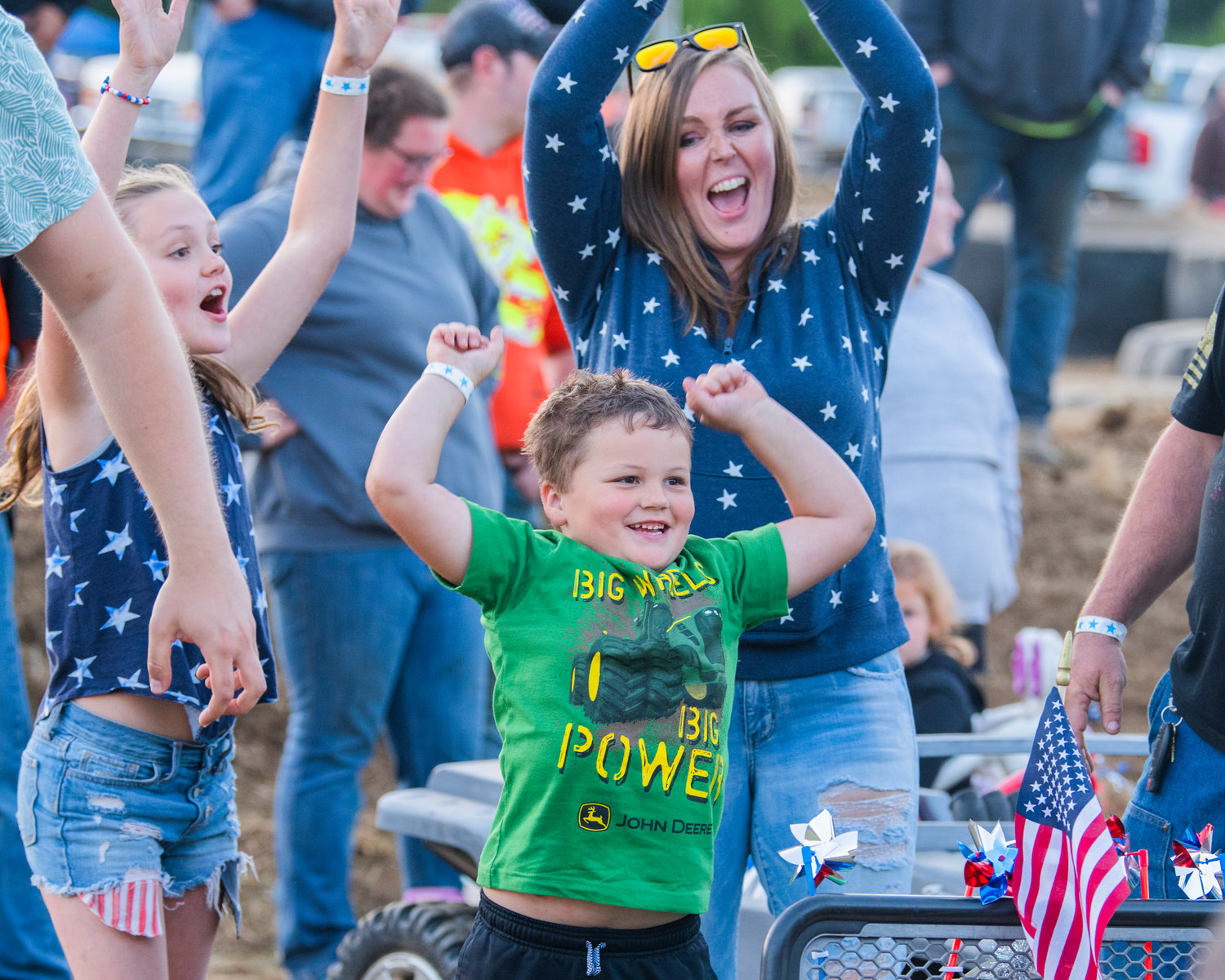 Cooper Burdick smiles and raises his hands after taking second place in the power wheels demolition derby for kids at the Southwest Washington Fairgrounds Sunday night during Summerfest in Centralia.