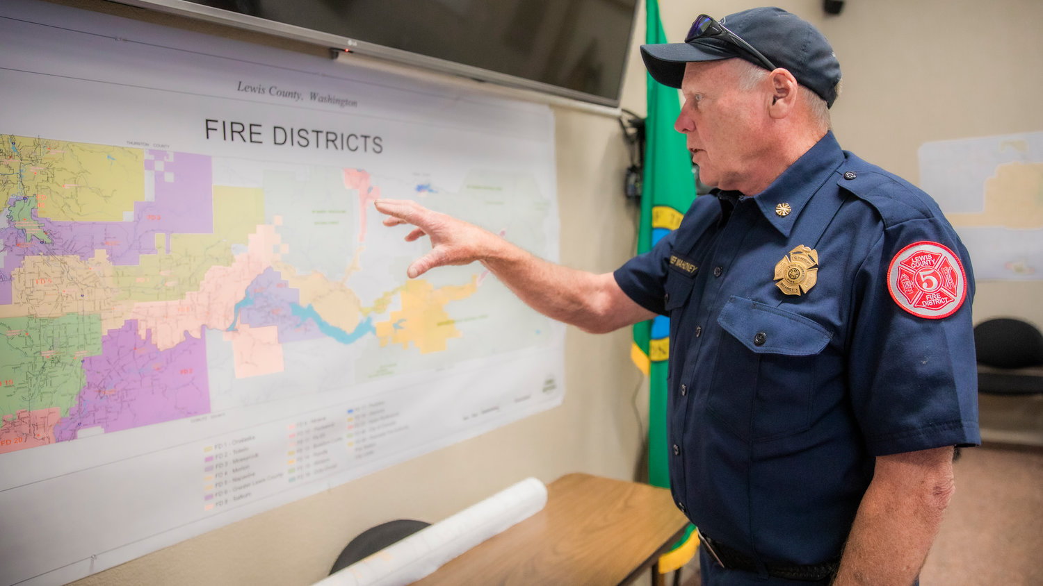 Lewis County Fire District 5 Chief Dan Mahoney points to a map of fire districts across the county last month.