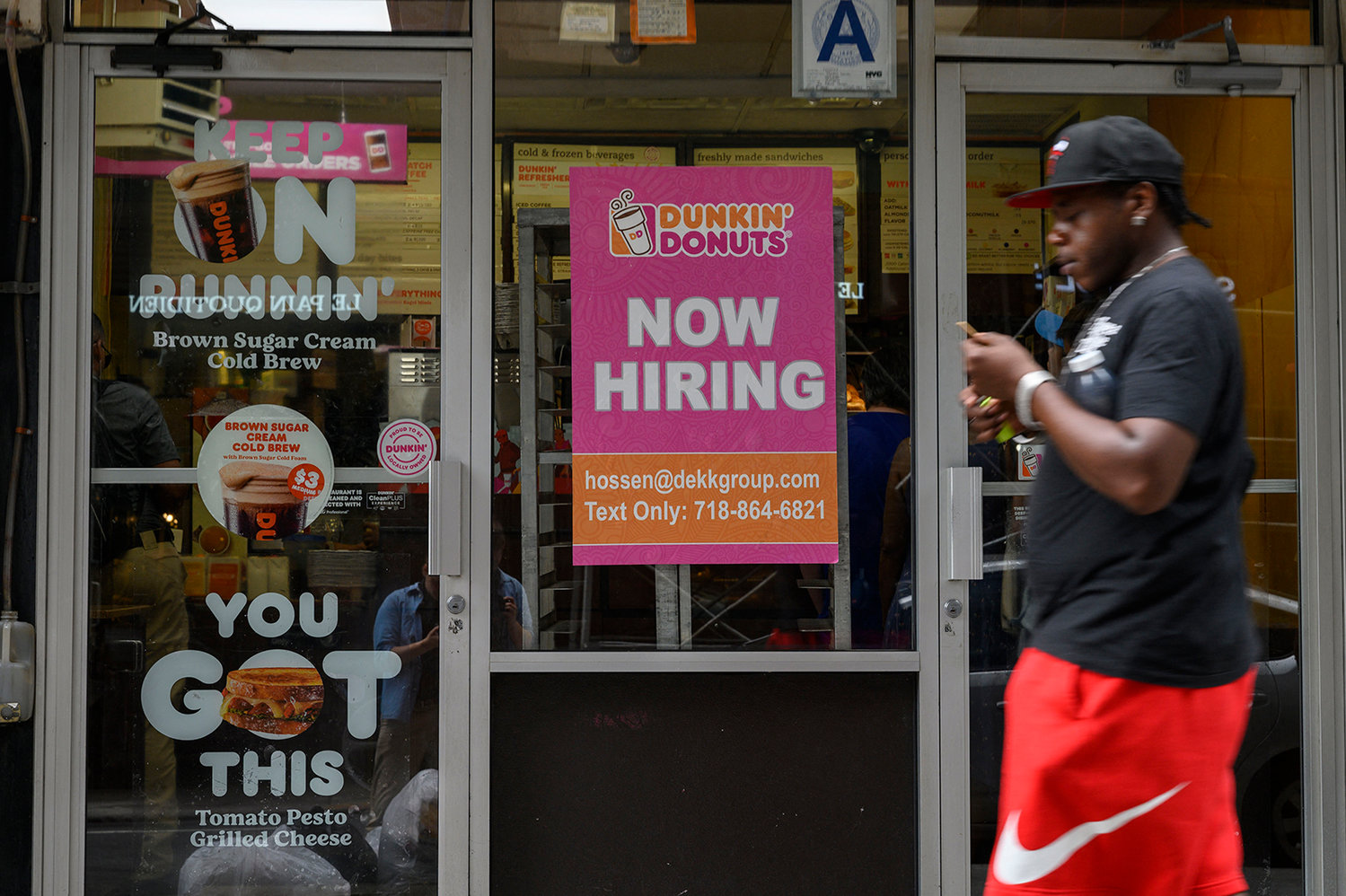 A man walks past a "Now Hiring" sign in New York City on July 8, 2022. (Angela Weiss/AFP via Getty Images/TNS)