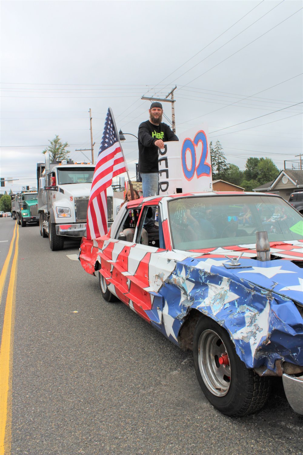 Jordan Hunter of Winlock waves from the top of Brad Hunter's demolition derby car, which won best of show at Centralia's Summerfest derby.