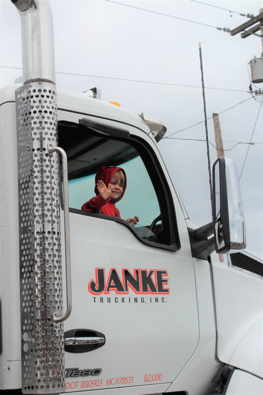 Malachi Merrill, 5, waves from one of a handful of Janke Trucking, Inc. trucks in the Napavine Funtime Festival parade Saturday.