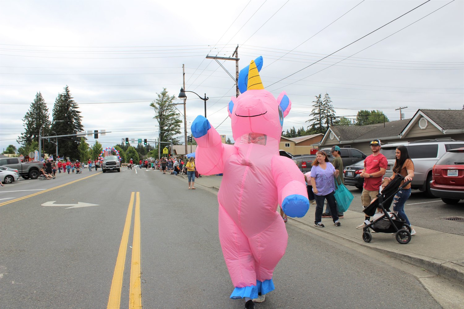 Shasta Morton dressed as a giant pink unicorn to accompany the Winlock Egg Days float in the Napavine Funtime Festival Saturday.