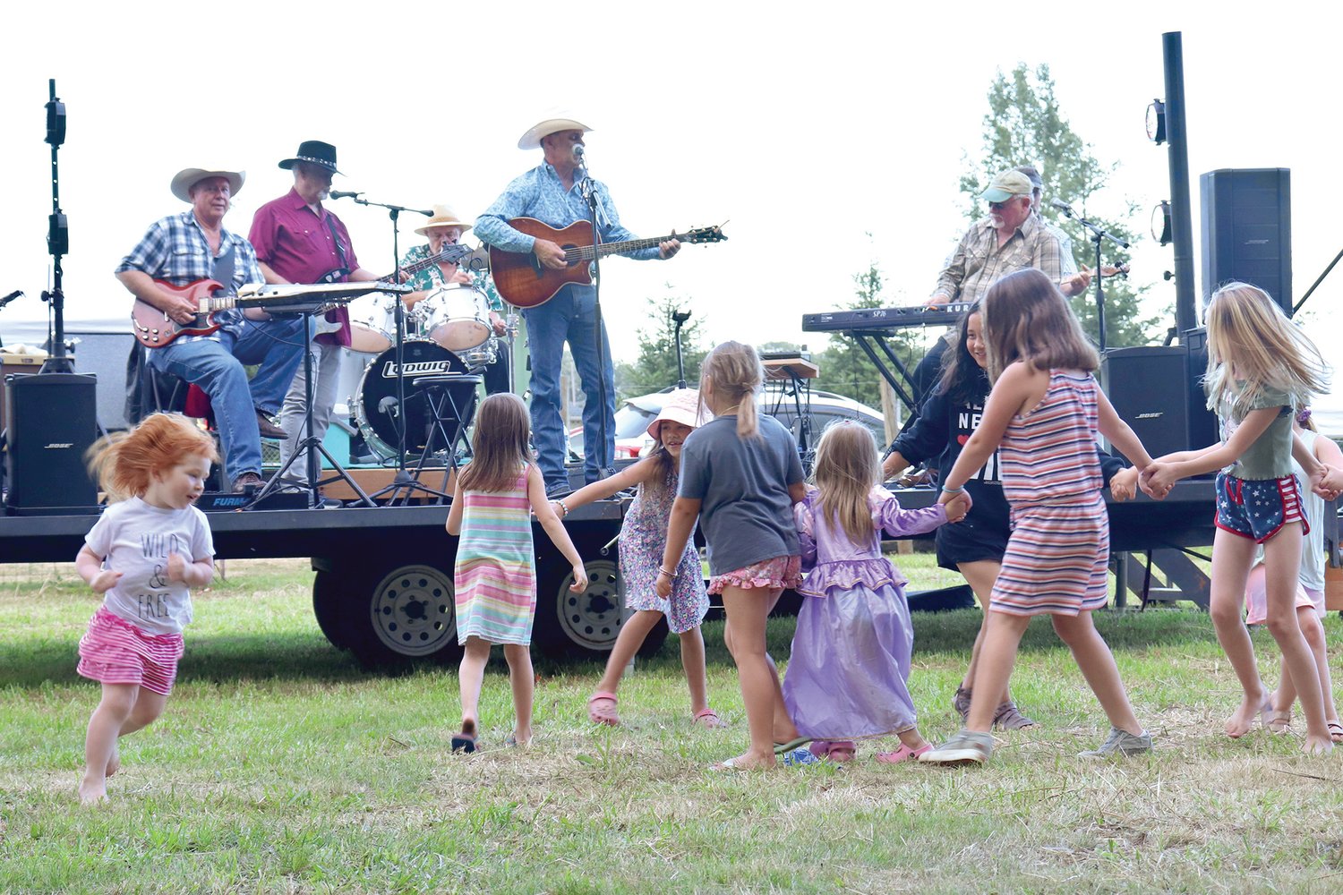 Kids dance along with a performance by Pat Murphy and the Straightshot Band at the Adna Car Show Camp & Cruise in Adna on Friday.