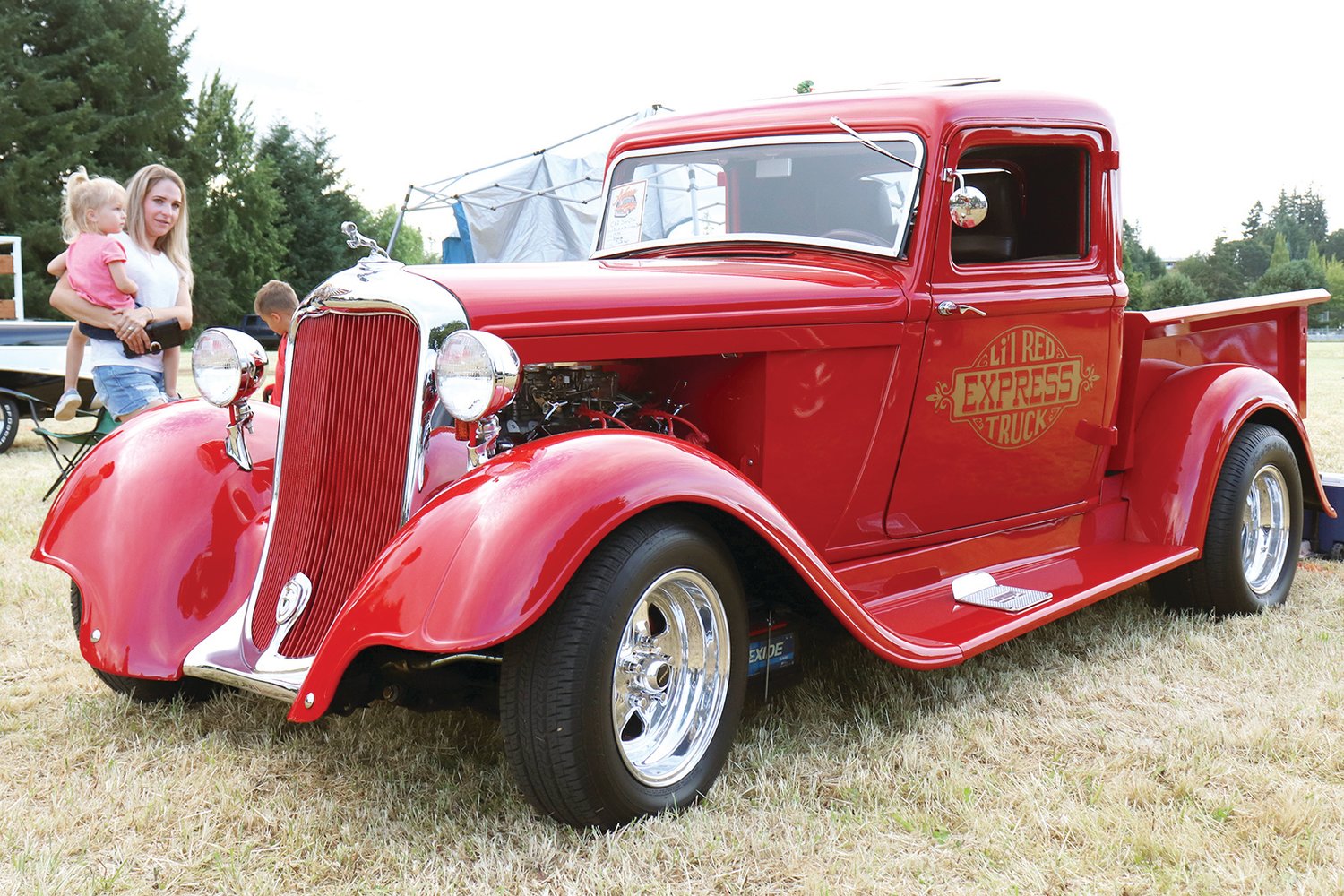 Adna Camp & Cruise Car Show attendees look over a 1935 Dodge Pickup in Adna on Friday.