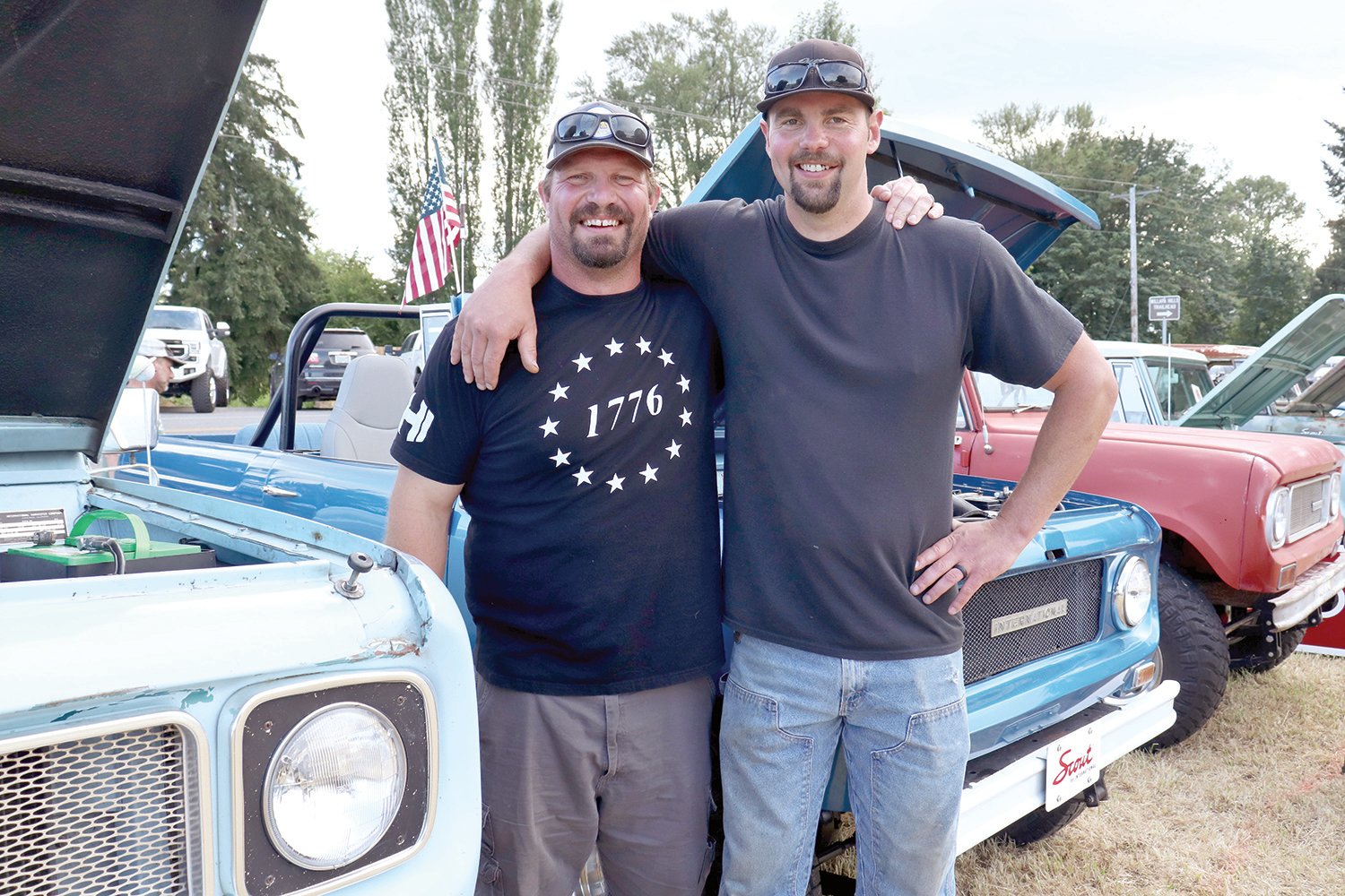 Josh Von Moos, left, and Zach Berg pose for a photo beside their vehicles at the Adna Camp & Cruise Car Show in Adna on Friday.
