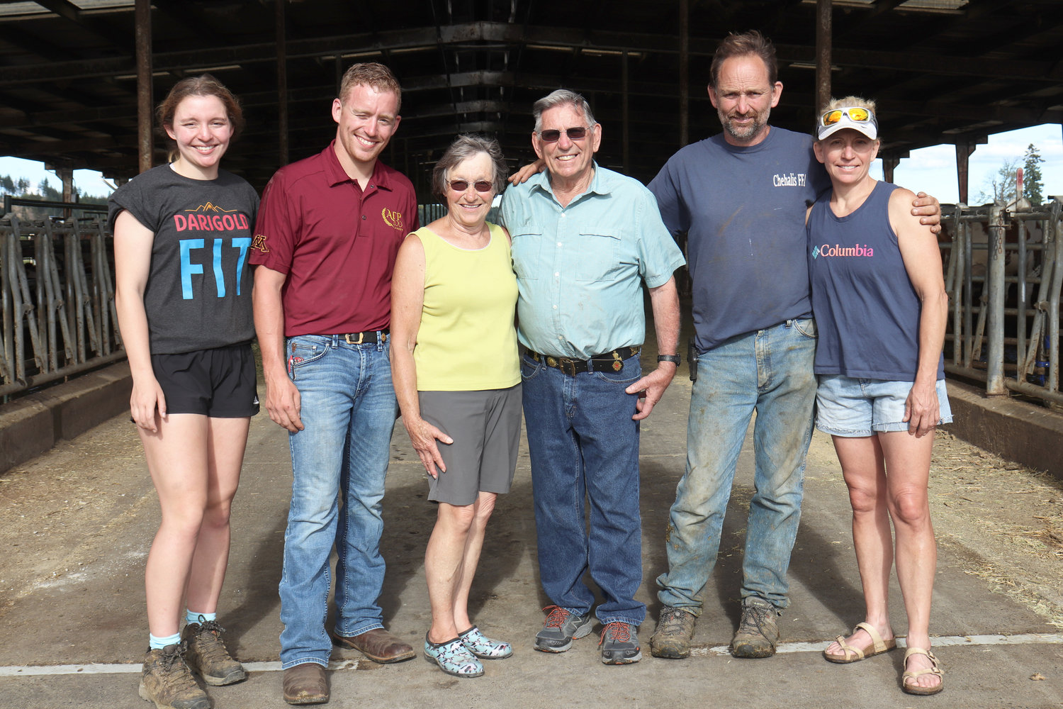 Sun-Ton Farms owners and operators, from left, Cassy, Zach, Sunny, Tony, Lonny and Michelle Schilter, pose for a photo in front of their barn during an open house in Adna on Friday.