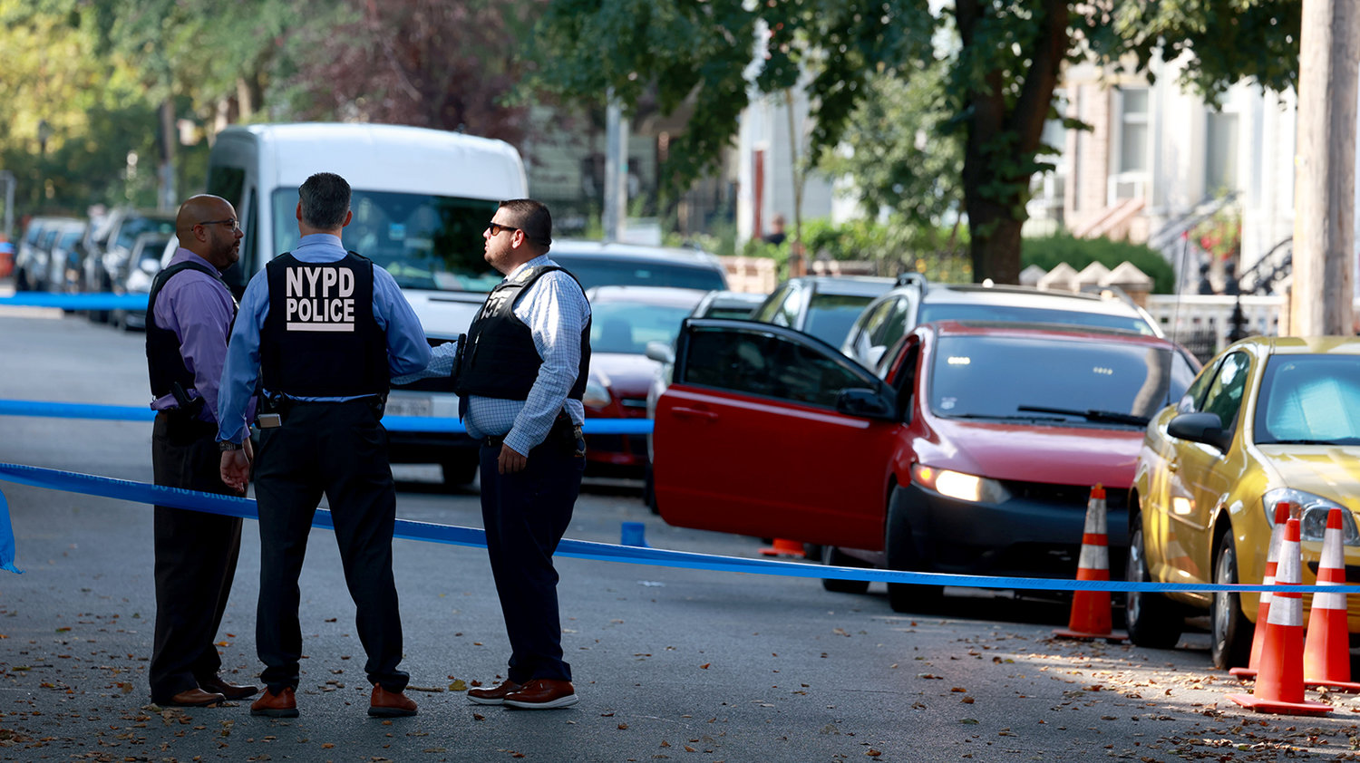 Detectives process the crime scene on North Henry Street where a man was shot while sitting on his car early Tuesday, July 19, 2022. (Luiz C. Ribeiro/New York Daily News/TNS)