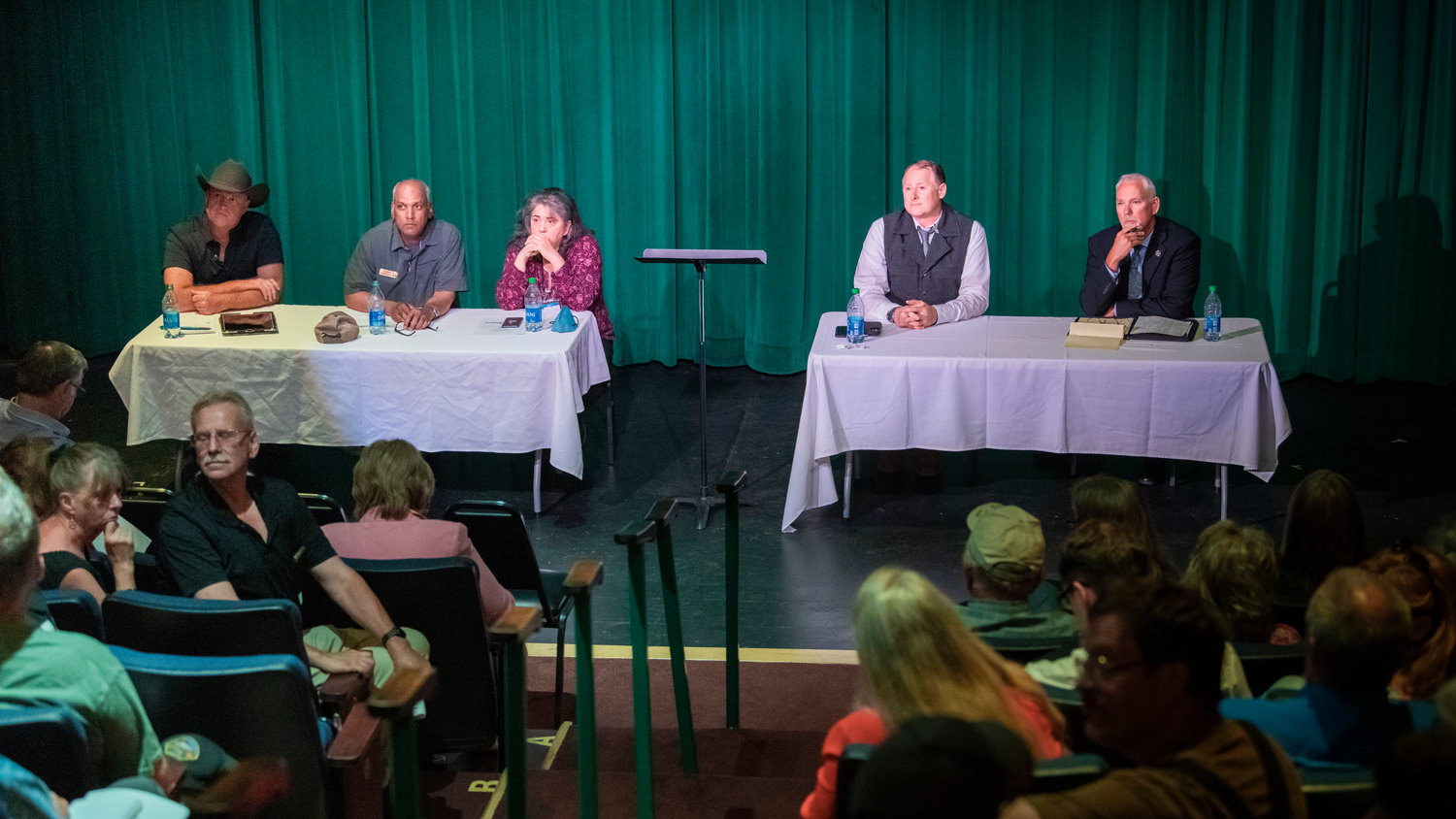 Candidates, from left, Scott Brummer, Harry Bhagwandin, Pat Saldaña, Tracy Murphy and Rob Snaza listen to questions from the crowd at the Roxy Theater in Morton on Tuesday.