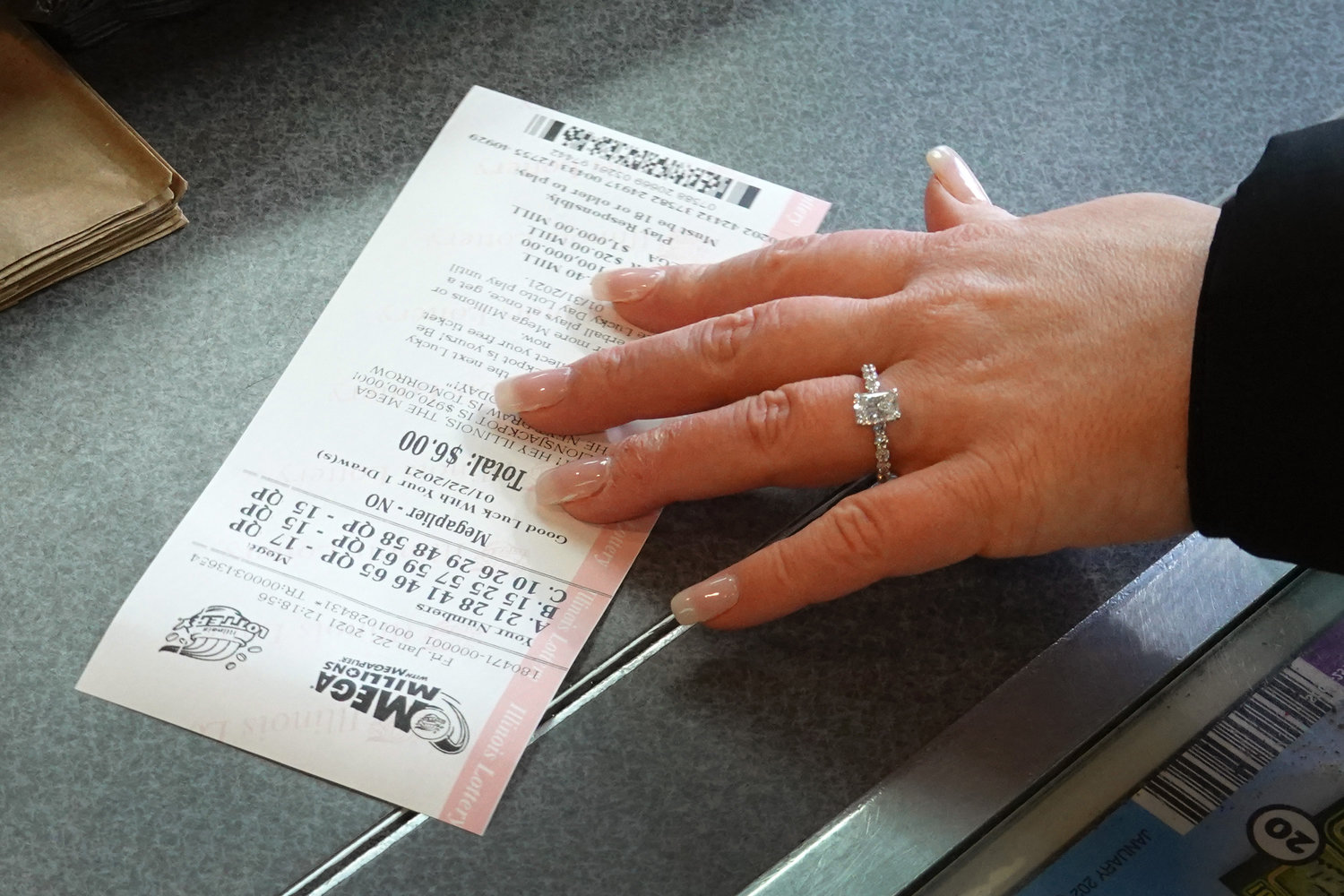 A customer purchases a Mega Millions lottery ticket at a 7-Eleven store in Chicago. (Scott Olson/Getty Images/TNS)
