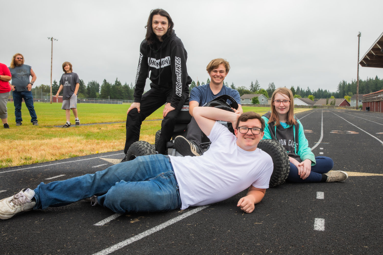 Sawyer Marshall, Luke Slagle, Dawson Cramer, and Starla Foister pose for a photo with their go-kart Thursday outside Napavine High School.