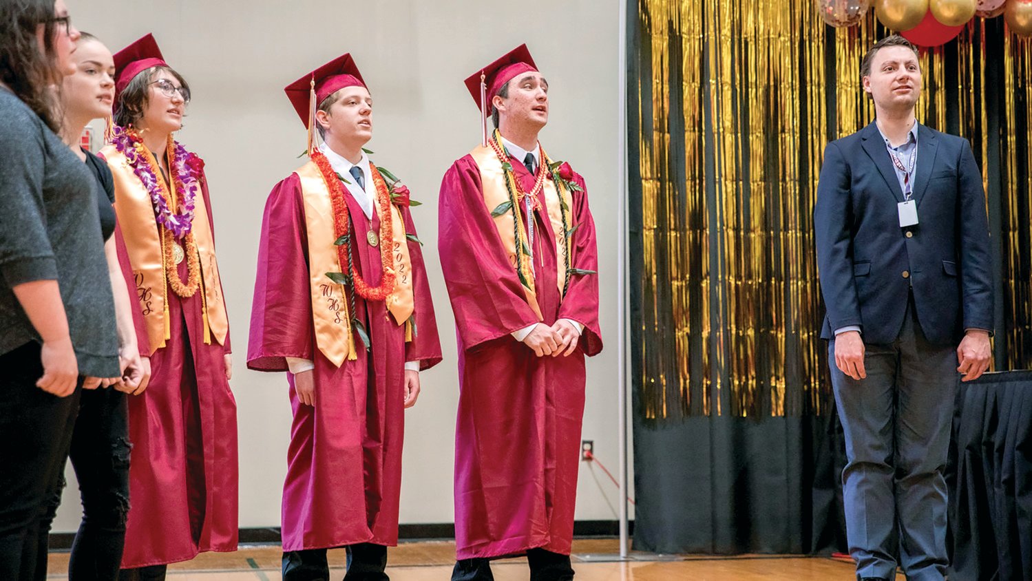 From left, 2022 Winlock High School graduates Taylor Ruiz, Neal Patching and Mekhi Morlin sing “The Rainbow Connection” during the graduation ceremony in early June.