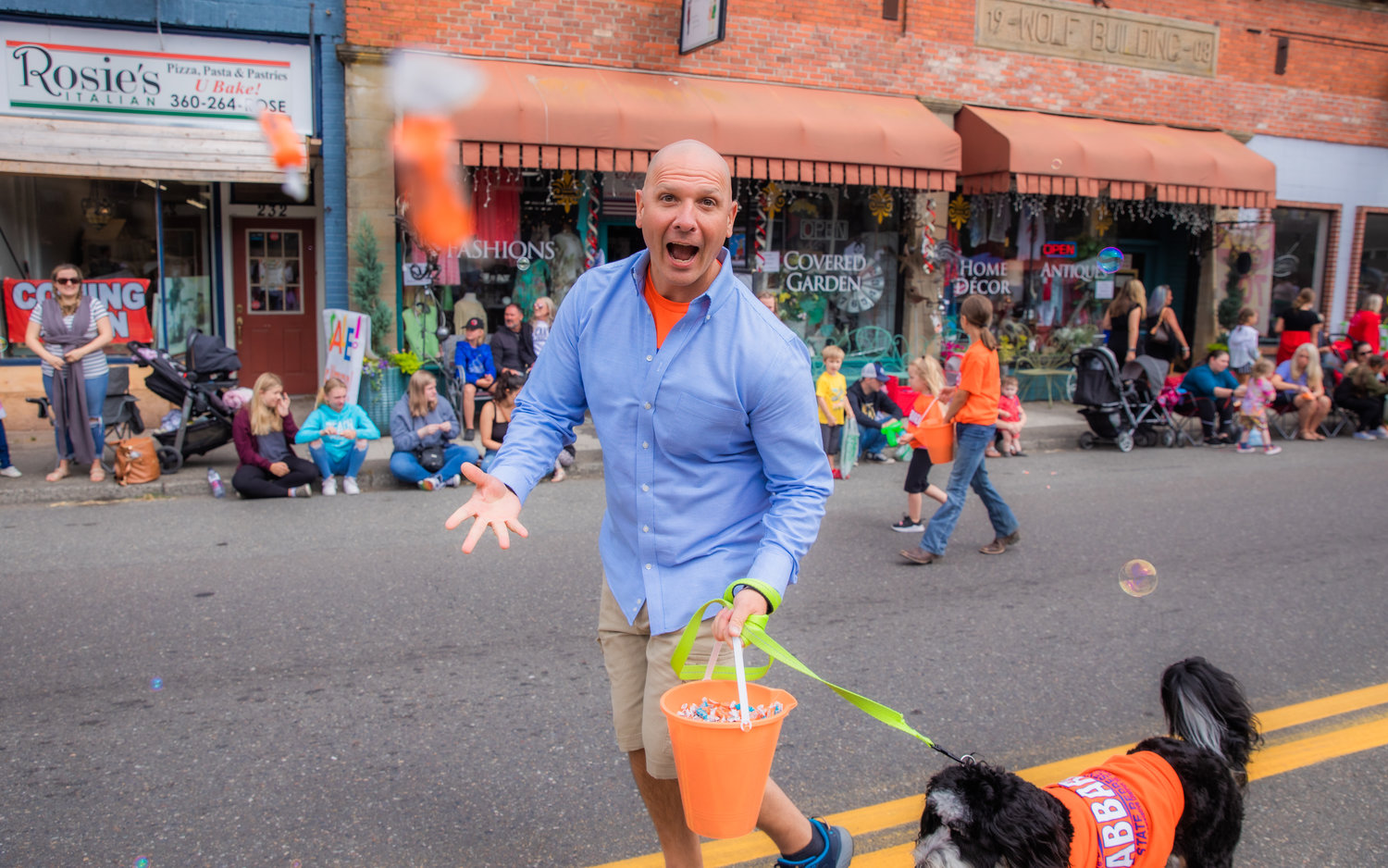 State Rep. Peter Abbarno throws candy at the camera during the Oregon Trail Days parade Saturday morning in Tenino.