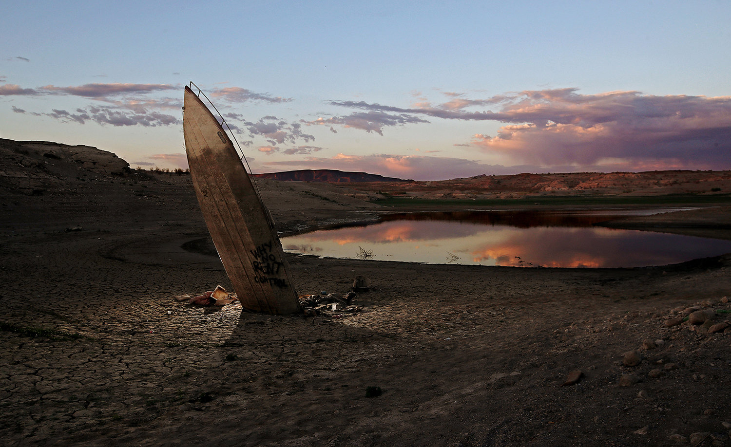 A boat that sank in Lake Mead is left embedded in the dry lake bed. (Luis Sinco/Los Angeles Times/TNS)