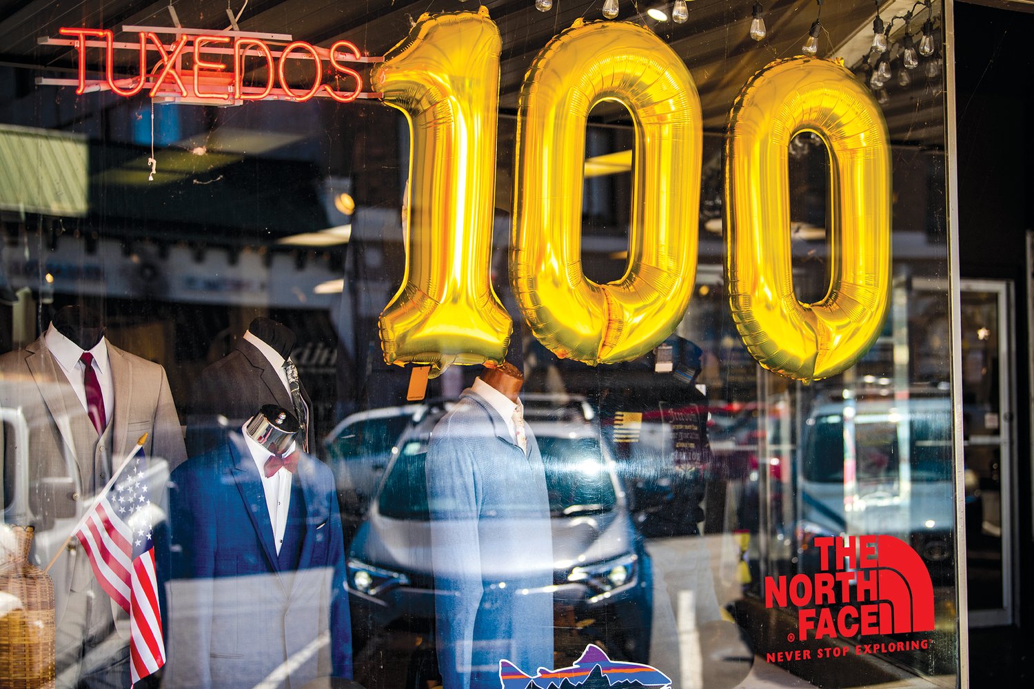 Suits and balloons are displayed behind glass at Bartel's in Chehalis for the 100 year celebration.