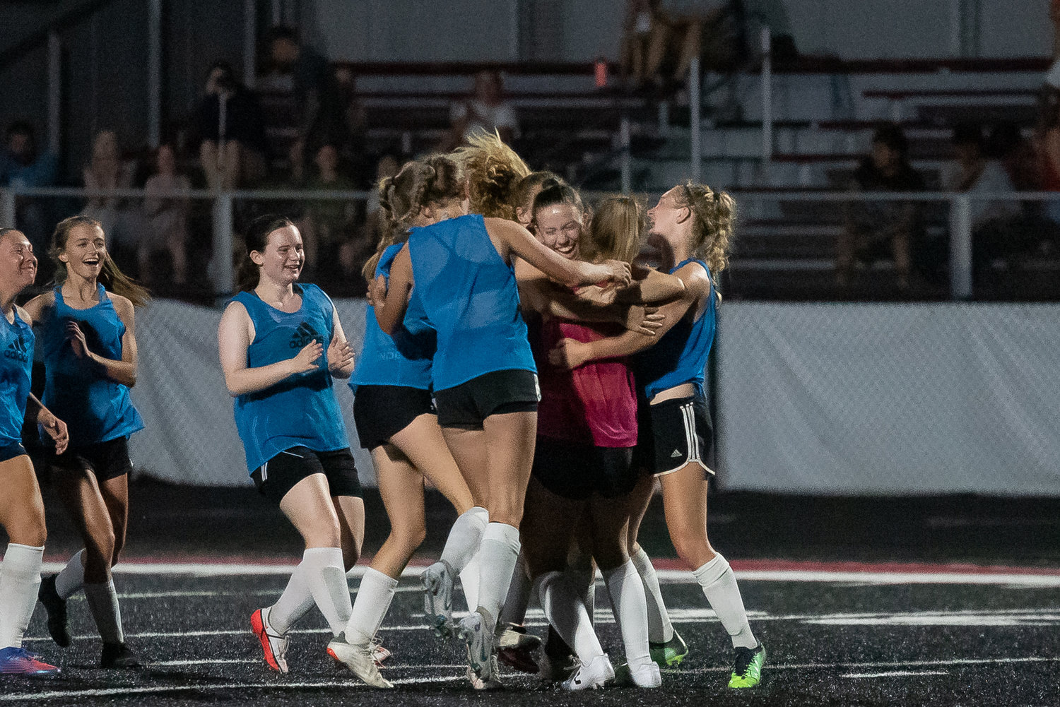The W.F. West girls soccer team celebrates after beating Centralia in the Battle on the Black Top championship game Sunday.