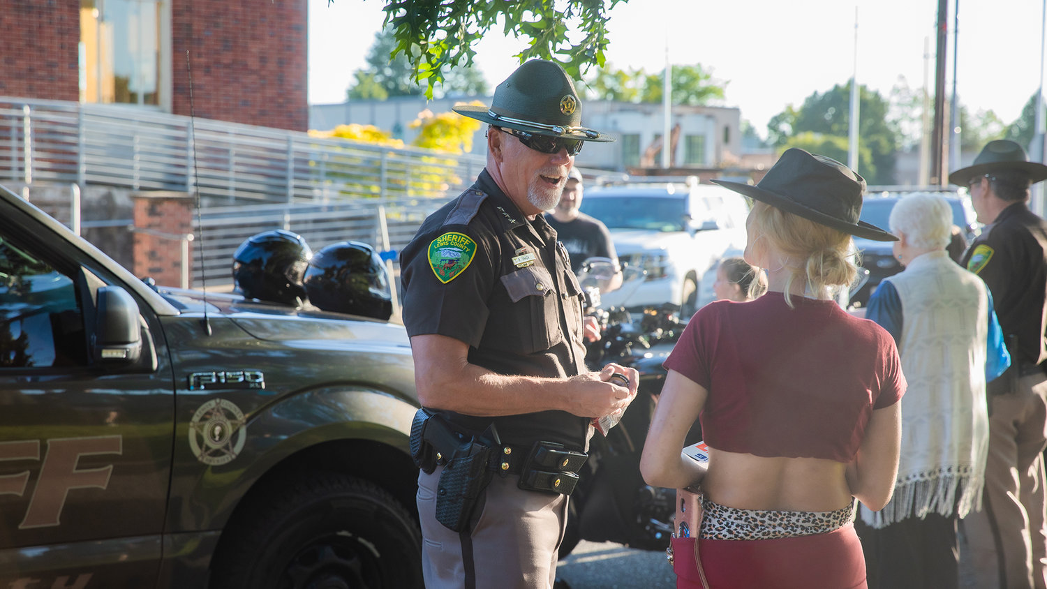 Sheriff Rob Snaza, with the Lewis County Sheriff’s Office, smiles while greeting attendees of a National Night Out event hosted Tuesday night at George Washington Park in Centralia.