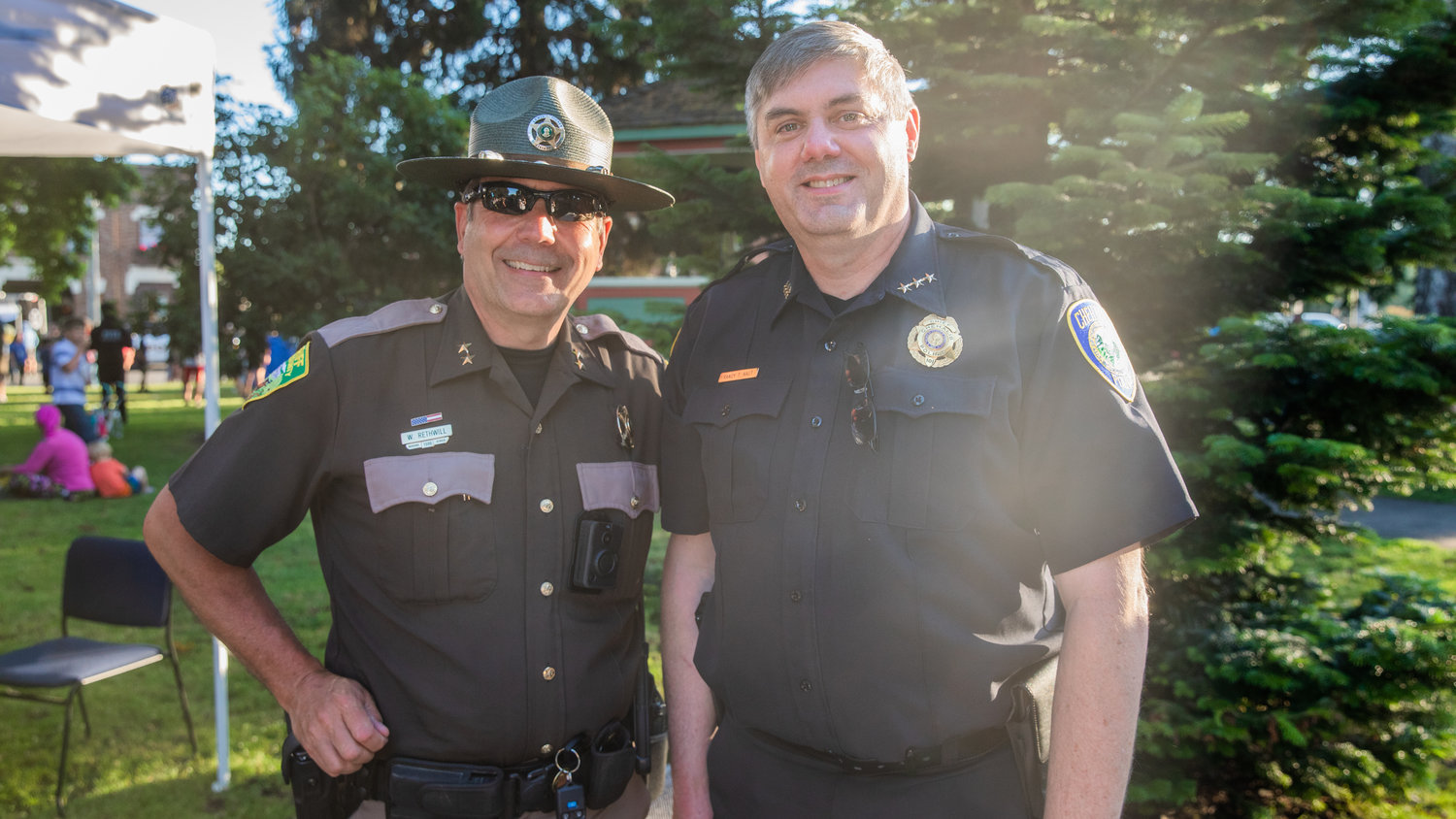 Undersheriff Wes Rethwill and Chehalis Police Chief Randy Kaut smile for a photo Tuesday in Centralia at George Washington Park during a National Night Out event.