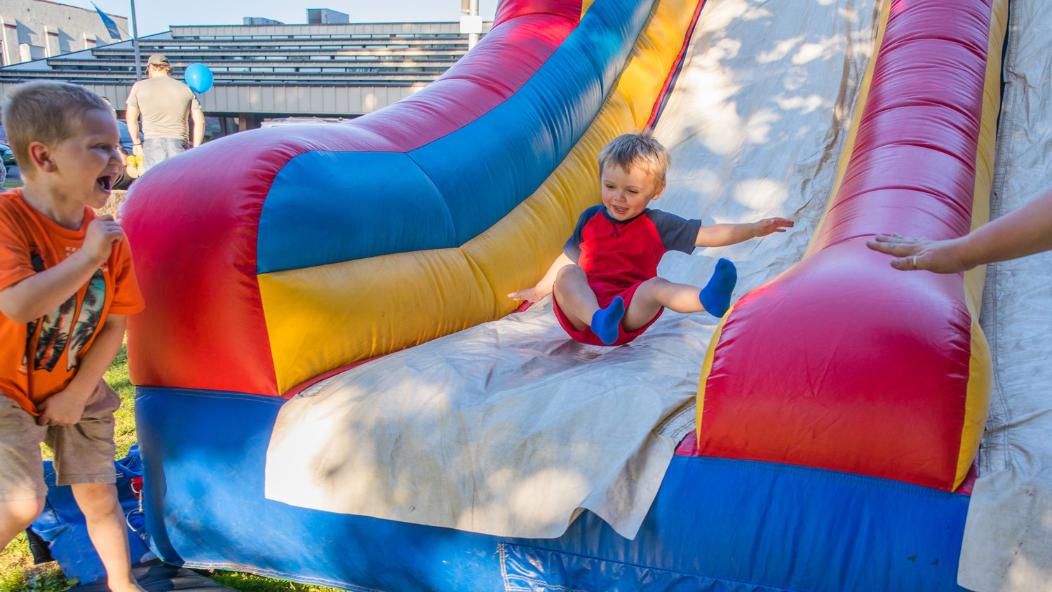 Greyson Driscoll, 3, bounces down a slide Tuesday evening at George Washington Park in Centralia during a National Night Out event.