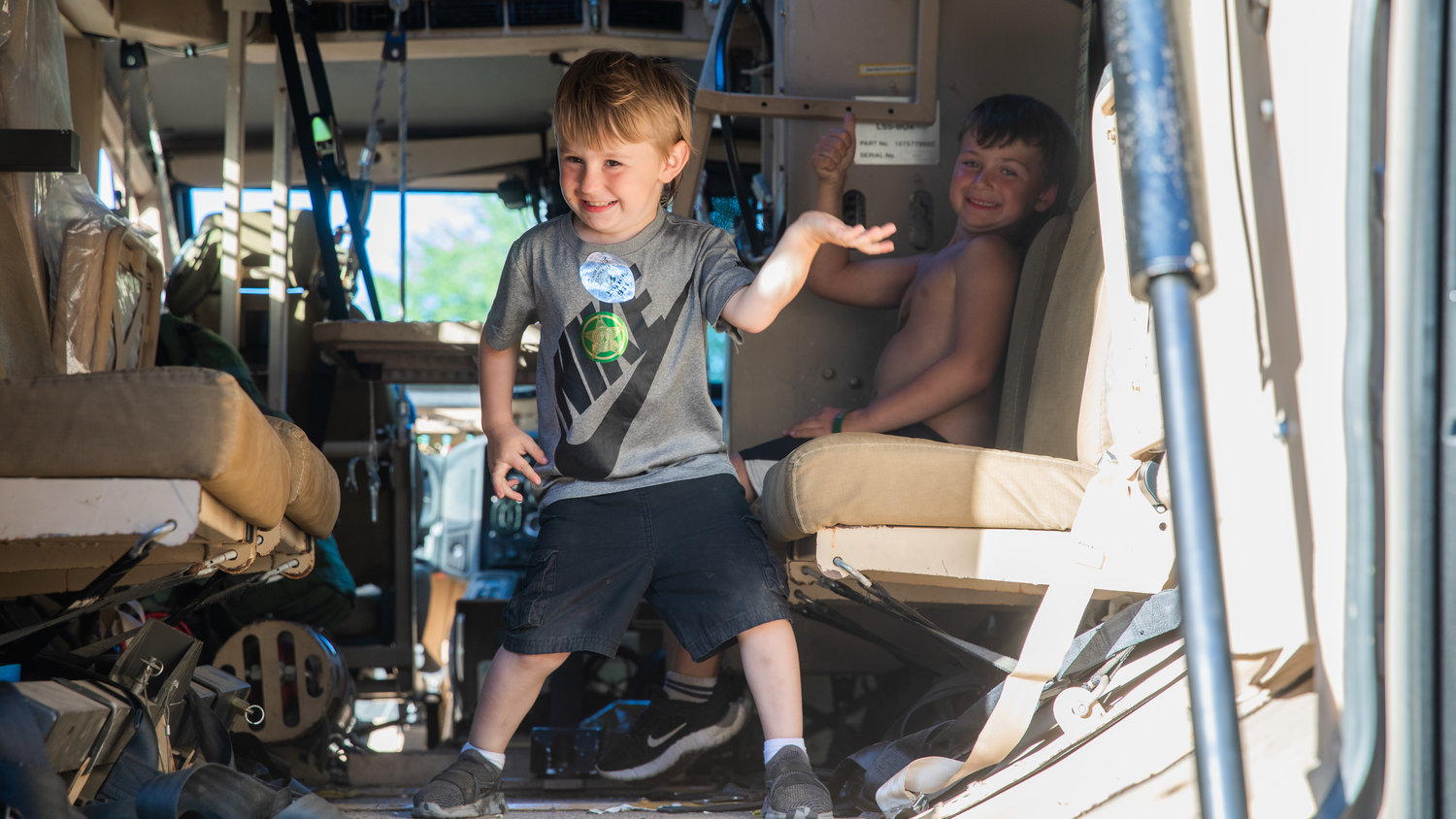 Bentley Andrews, 4, and Kyson Roberts, 6, pose for a photo Tuesday in the back of a Law Enforcement vehicle at George Washington Park during a National Night Out event in Centralia.