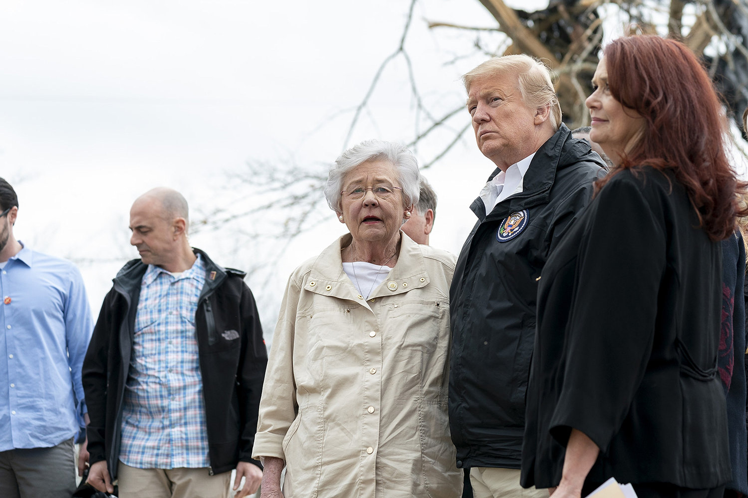 Then U.S. President Donald Trump surveyed storm damage and met with residents along with Alabama Gov. Kay Ivey, center, March 8, 2019 in Opelika, Alabama. Trump is the leading candidate for GOP presidential nomination, according to a CPAC poll taken Saturday, Aug. 6, 2022. (Shealah Craighead/White House via ZUMA Wire/TNS)