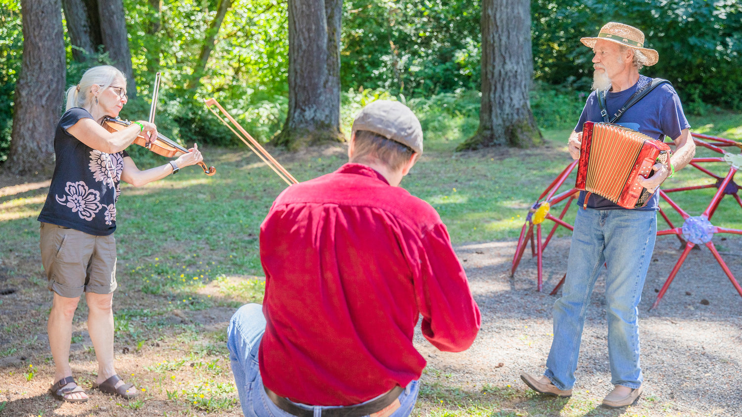 From left, Amy Bury, Steve Cox and Geoff Bury play instruments at Winolequa Memorial Park in Winlock Saturday morning.