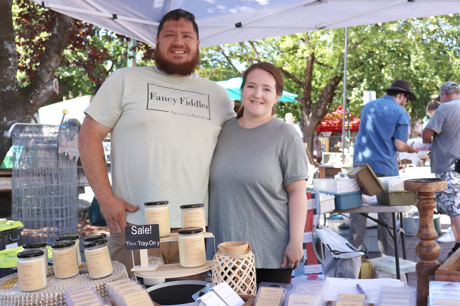 Anthony Favro and Leah Truax of Fancy Fiddles, a handmade home- and body-goods shop based in Chehalis, run a booth at Antique Fest in downtown Centralia on Sunday.