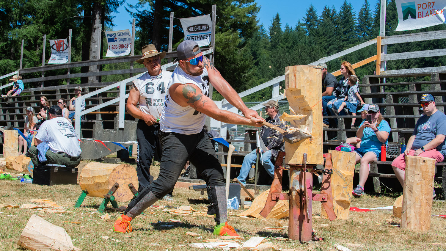 Wood splinters as Mike Johnson makes contact with his axe Sunday afternoon during the vertical chop event inside the Morton Loggers’ Jubilee Arena.