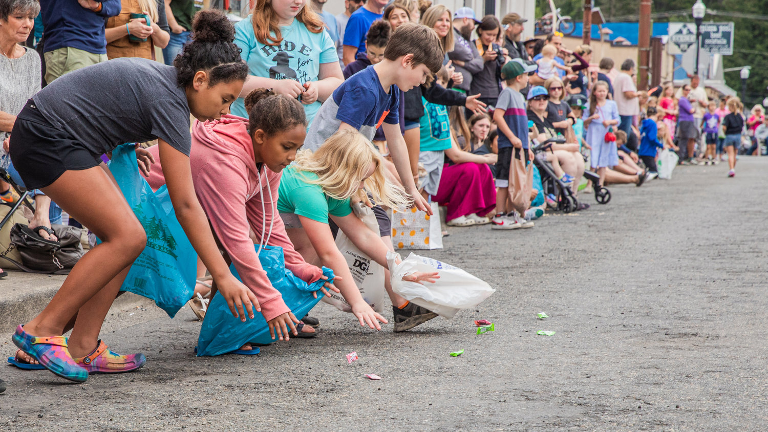 Kids lunge for candy in downtown Morton on Saturday.