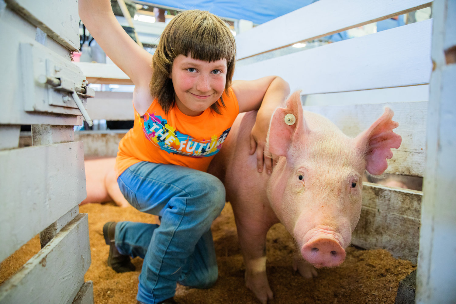 Dalton South, 12, of Pe Ell, smiles for a photo with Bacon, a Yorkshire-mix, Monday at the Southwest Washington Fairgrounds in Centralia.