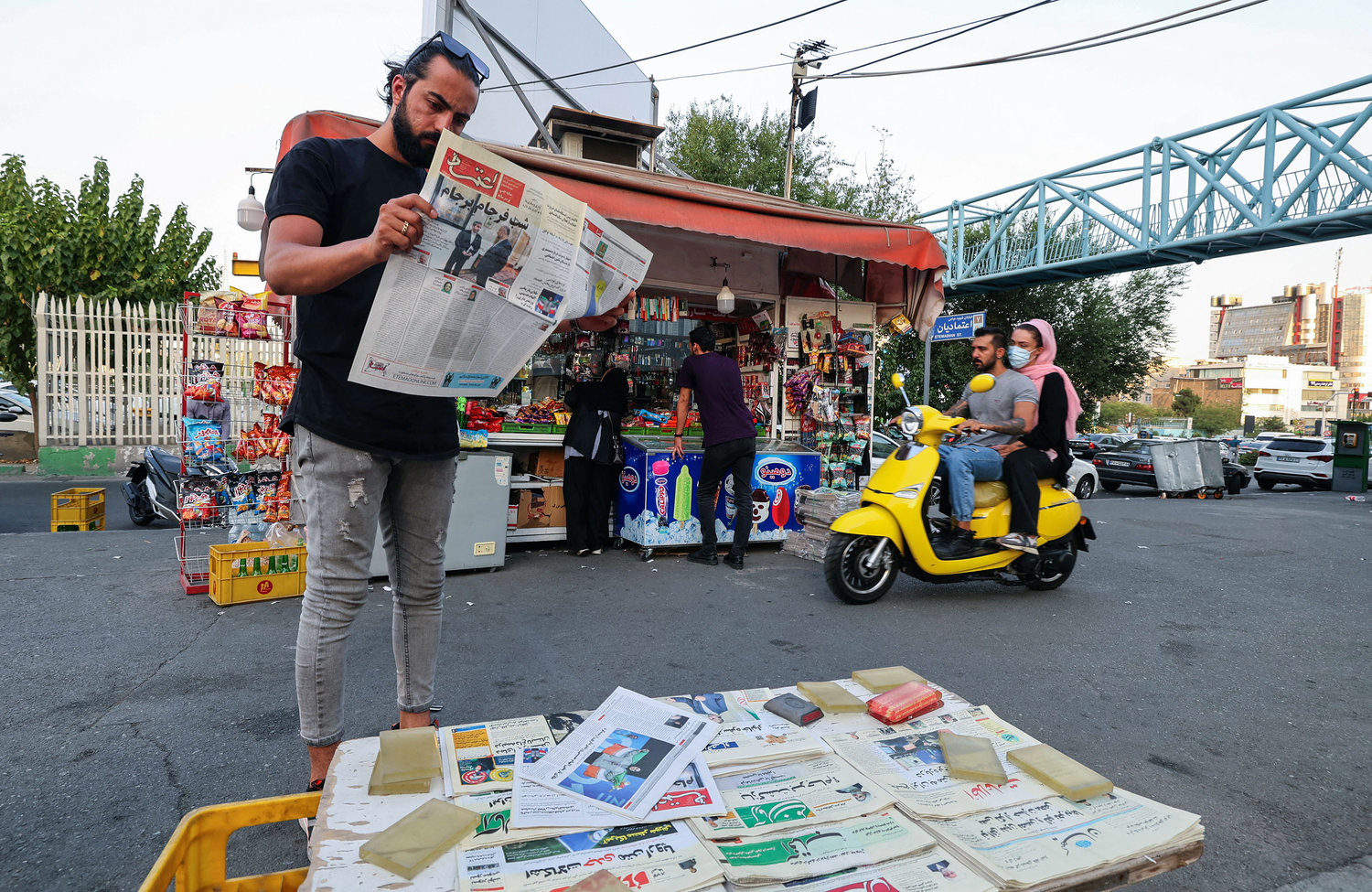 A man reads the Iranian newspaper Etemad, with the front page title reading in Farsi "The night of the end of the JCPOA," and cover photos of Iran's Foreign Miniser Hossein Amir-Abdollahian and his deputy and chief nuclear negotiator Ali Bagheri Kani, in the capital Tehran, on Tuesday, Aug. 16, 2022. (Atta Kenare/AFP/Getty Images/TNS)
