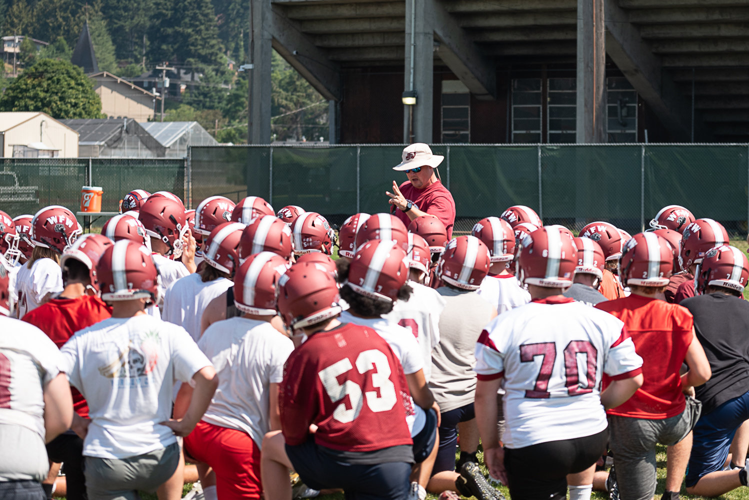 W.F. West coach Dan Hill talks with his team during the first day of fall camp in Chehalis Aug. 17.