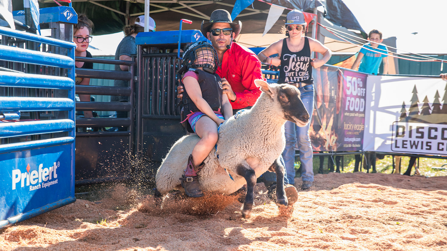 Jordyn Navloynski, 7, holds on tight as a sheep busts out of the starting gate Tuesday at the Southwest Washington Fairgrounds in Centralia.