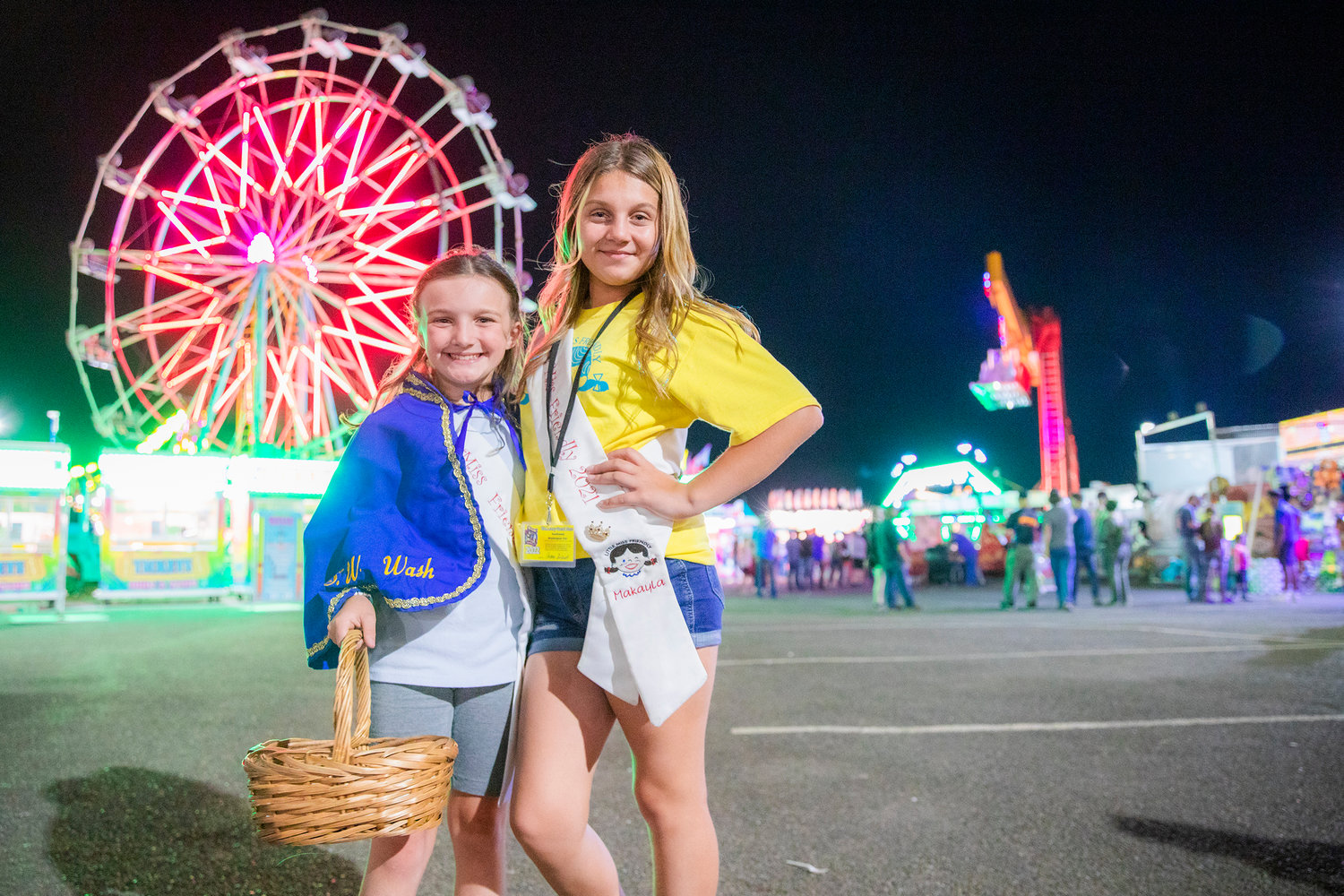 Newly caped Little Miss Friendly 2022 Emma Britton, left, poses with Little Miss Friendly 2021 MaKayla Maynard at the Southwest Washington Fair Tuesday night.