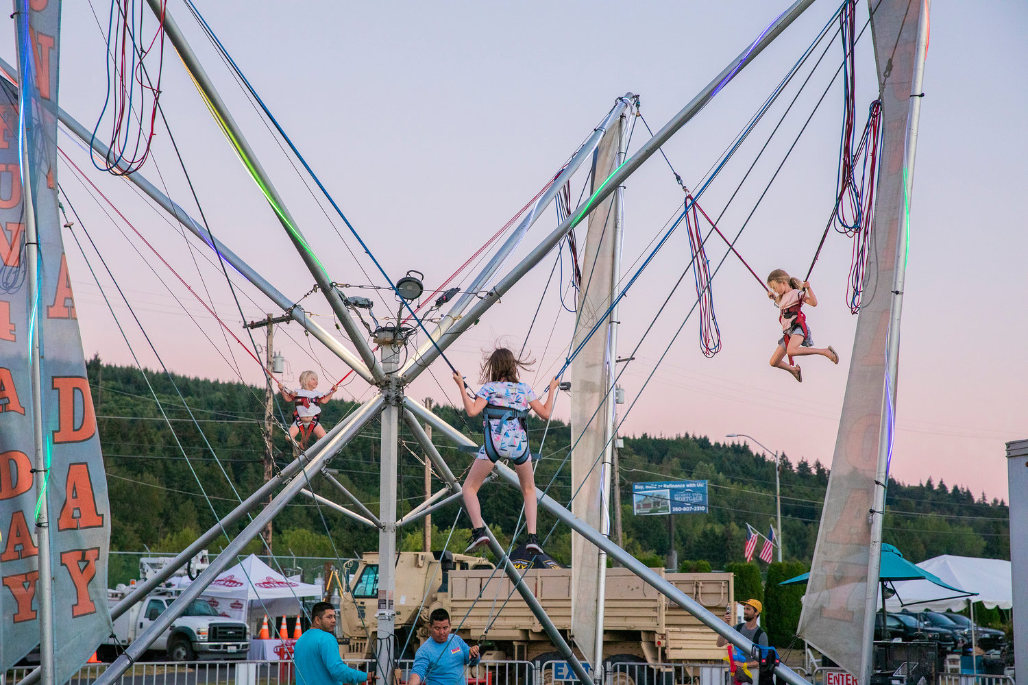 Kids smile and bounce at the Southwest Washington Fairgrounds Tuesday evening in Centralia.