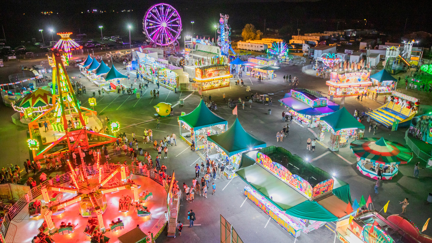 Lights illuminate rides and carnival games at the Southwest Washington Fairgrounds Tuesday night in Centralia.