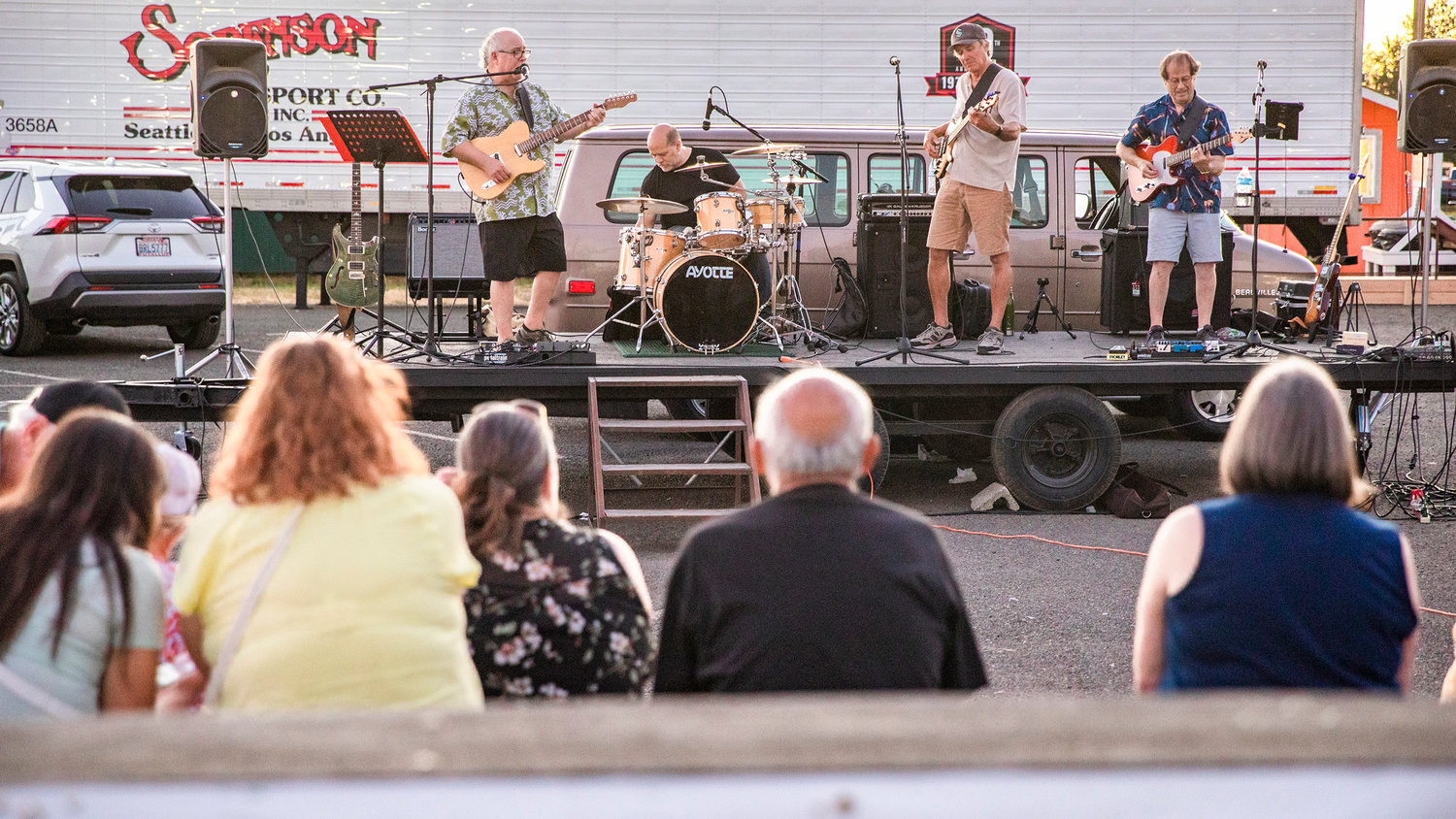 Visitors watch and listen as a band performs Tuesday night at the Southwest Washington Fairgrounds in Centralia.